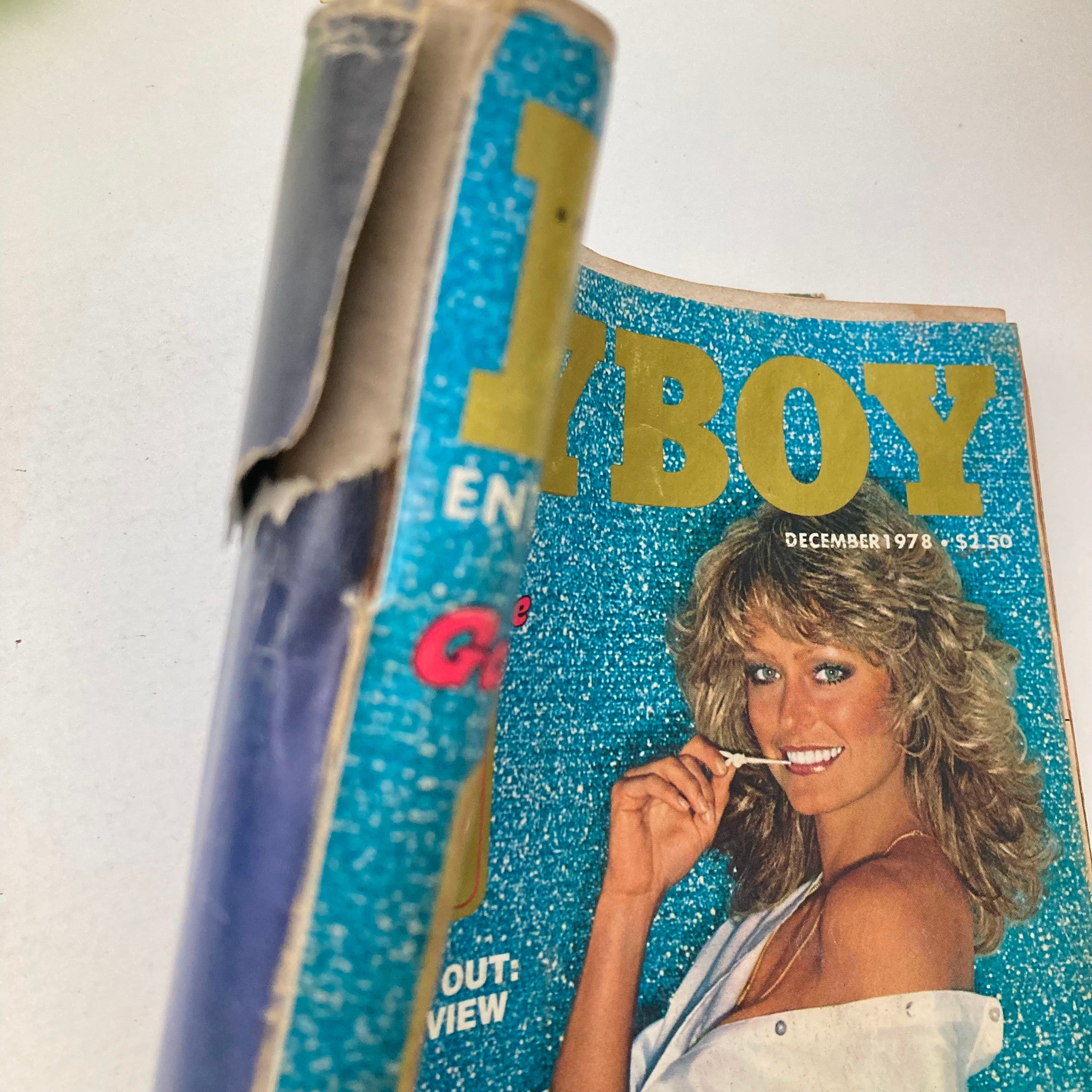 Side view of VTG Playboy Magazine December 1978, displaying the magazine's spine and creased cover featuring Playmate Janet Quist.