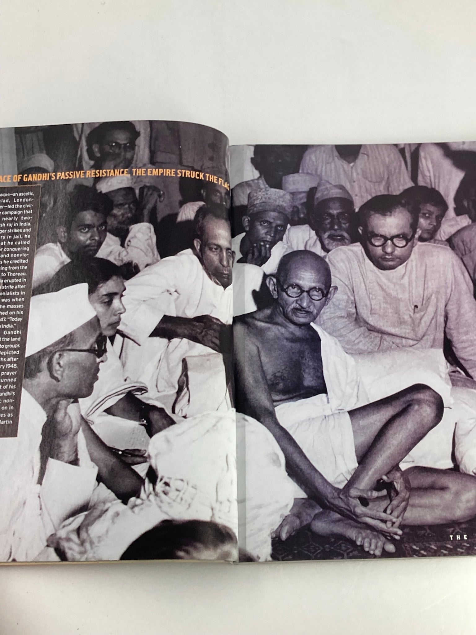 People Weekly Magazine 1998 page depicting Mahatma Gandhi during a meeting, reflecting his role in promoting non-violent resistance.