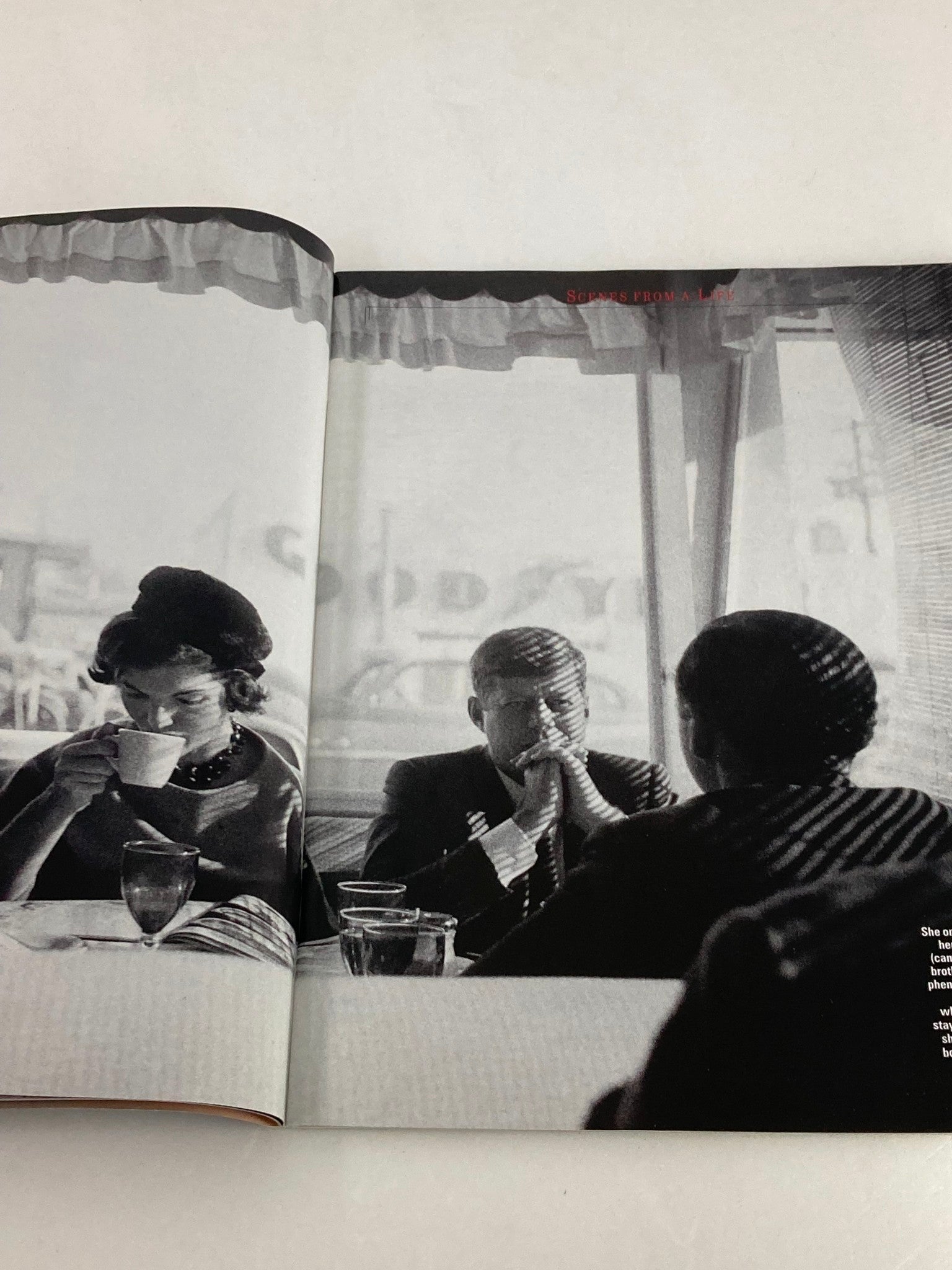 A black and white photo in People Weekly Tribute Magazine Summer 1994, depicting Jacqueline Kennedy Onassis engaged in a conversation at a dining table.
