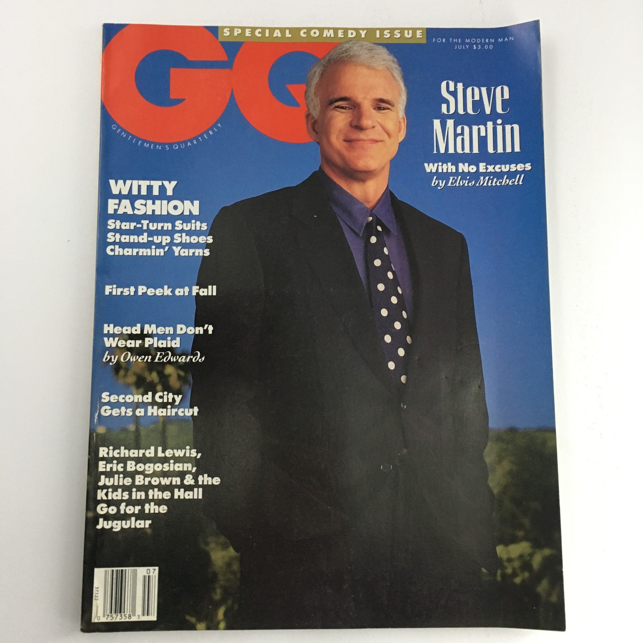 GQ Magazine July 1990 featuring Steve Martin on the cover as part of a special comedy issue, with the title "No Excuses" by Elvis Mitchell. The magazine showcases a modern man in stylish attire.