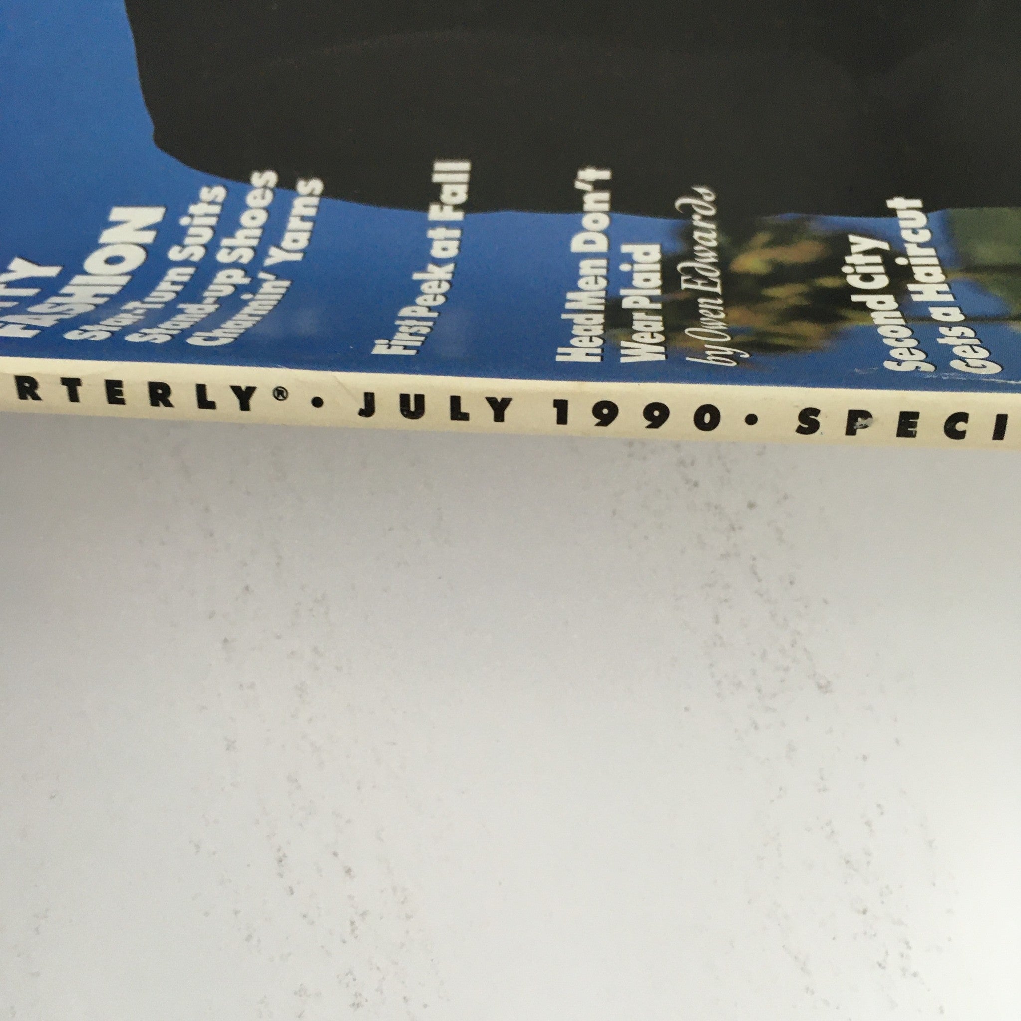 Side view of GQ Magazine July 1990 highlighting the publication name, date, and special issue designation, focusing on themes of witty fashion and notable comedy features.