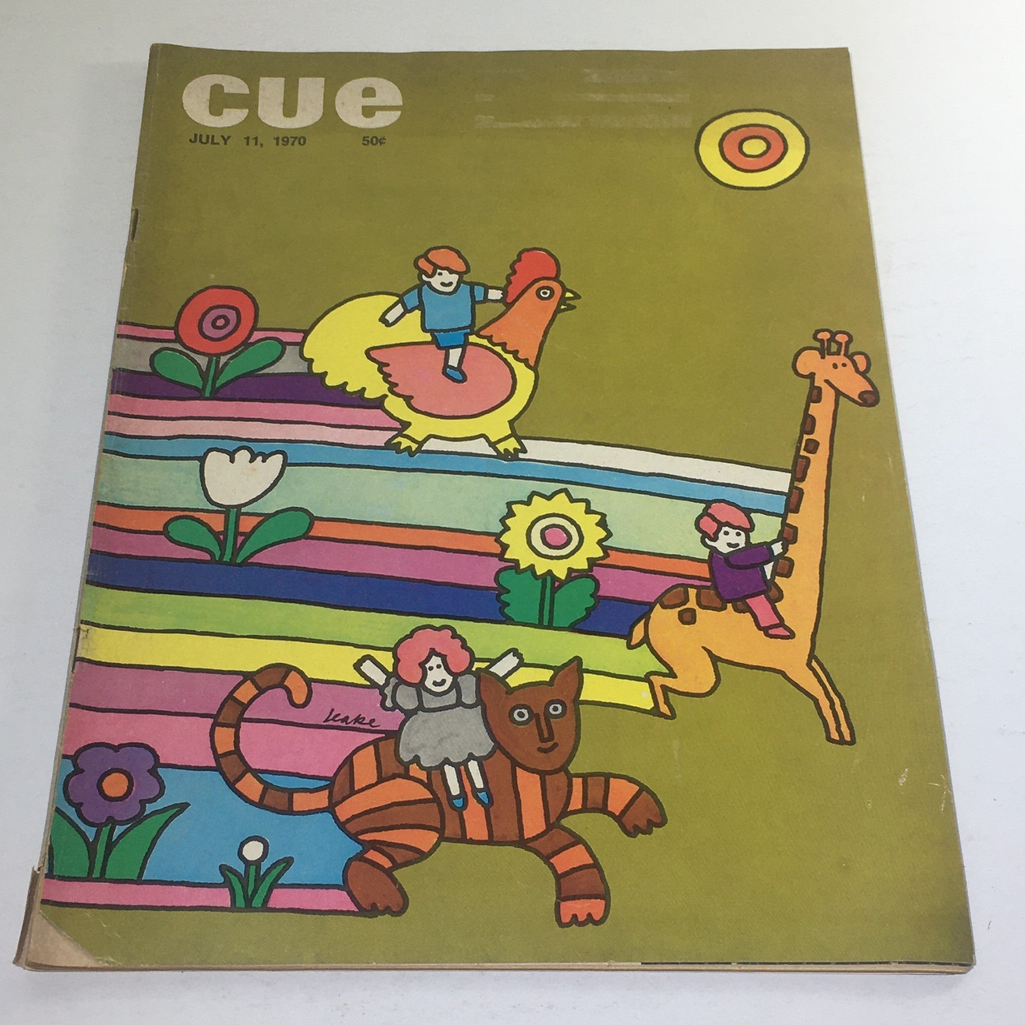Cue Magazine, July 11, 1970 - Theme cover artwork featuring colorful illustrations of children riding animals, including a giraffe and a chicken, designed by Don Leake.