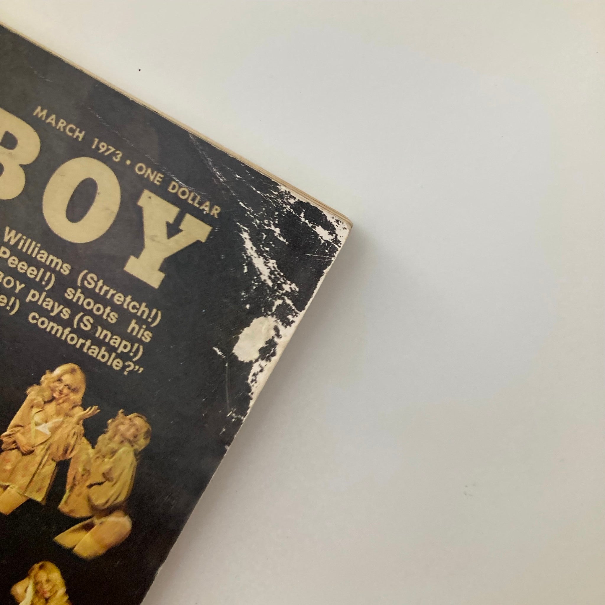 Close-up shot of the top corner of the VTG Playboy Magazine March 1973, highlighting some wear on the cover along with the magazine's title.