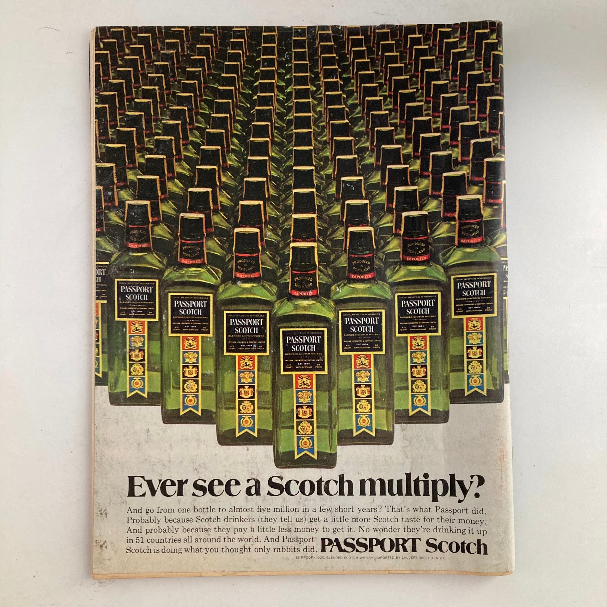 Advertisement page from VTG Newsweek Magazine May 21 1973 showcasing Passport Scotch with a visual of numerous bottles.