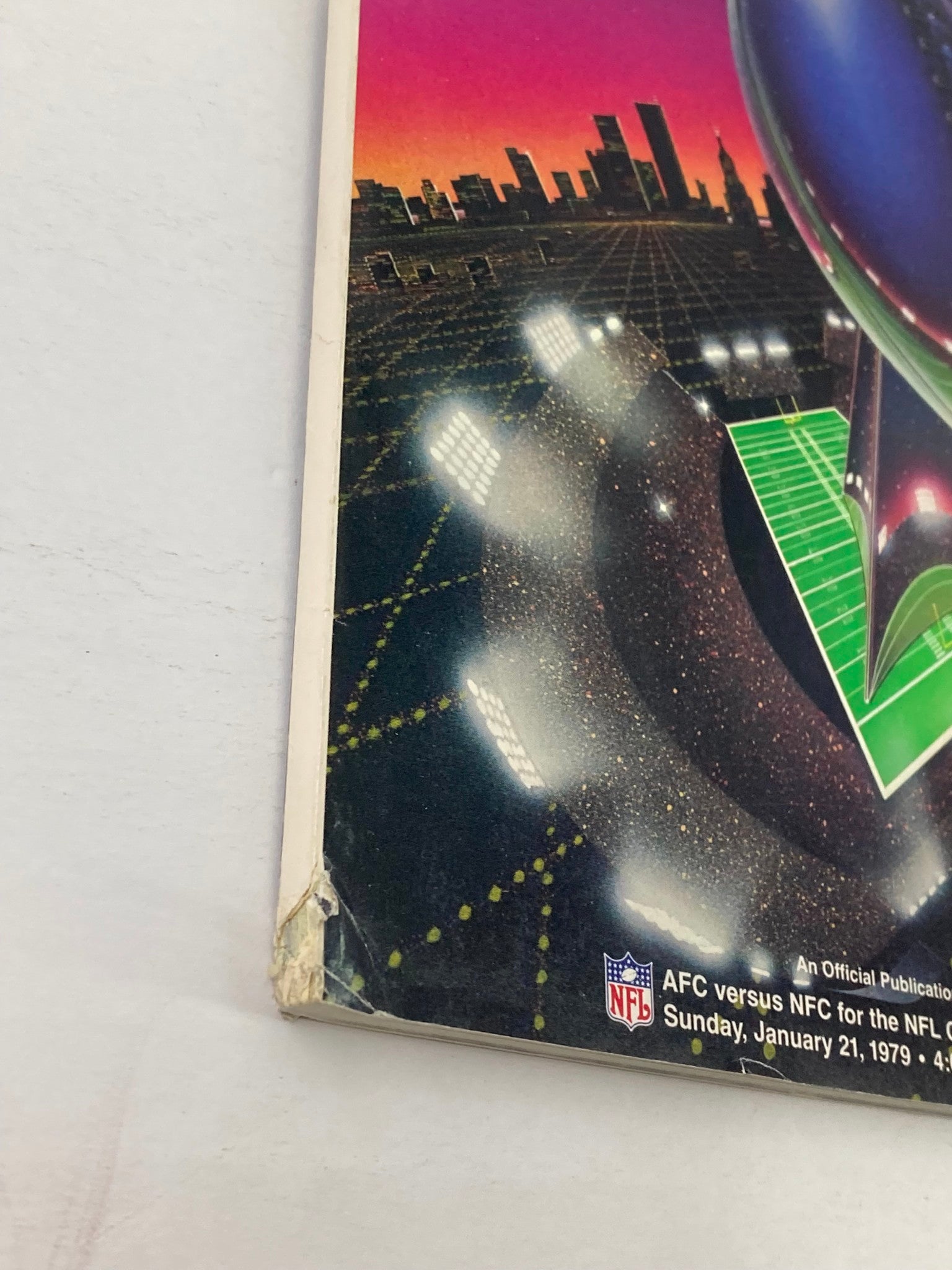 Side view of the 1979 NFL Super Bowl XIII Magazine, showing wear and tear typical of vintage publications, with clear visibility of the title and details about the event.