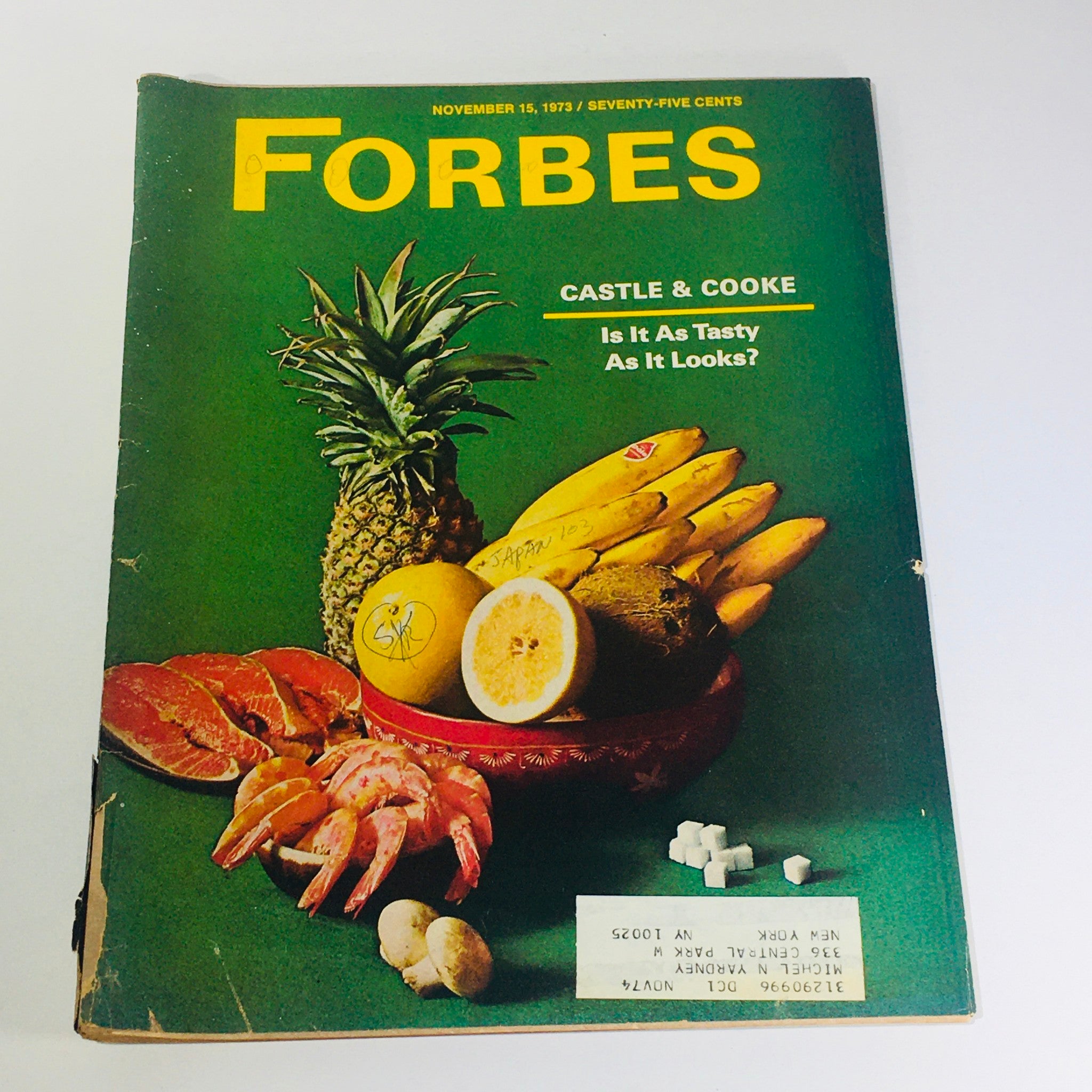 Cover of Forbes Magazine dated November 15, 1973, featuring a pineapple, bananas, grapefruit, shrimp, and other fruits with the title 'Castle & Cooke: Is It Tasty As It Looks?' in bold yellow text.