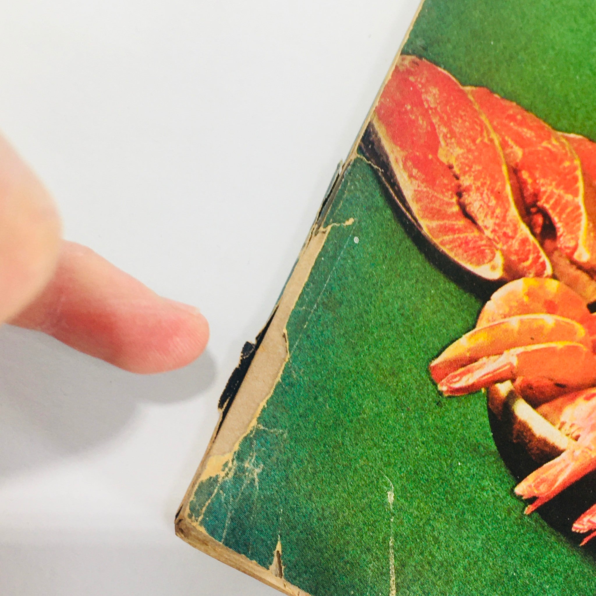 Close-up of the damaged edge of the Forbes Magazine cover dated November 15, 1973, highlighting wear and tear, while featuring the title 'Castle & Cooke: Is It Tasty As It Looks?'.