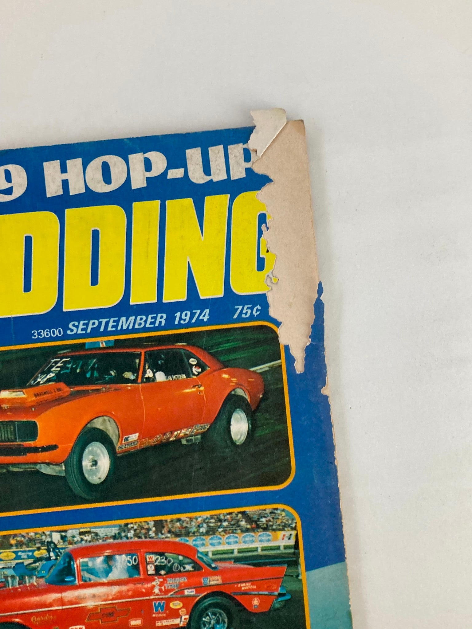 Cover detail of VTG Hot Rodding Magazine September 1974, showing wear and tear on the corner, featuring a colorful design and the title prominently displayed.