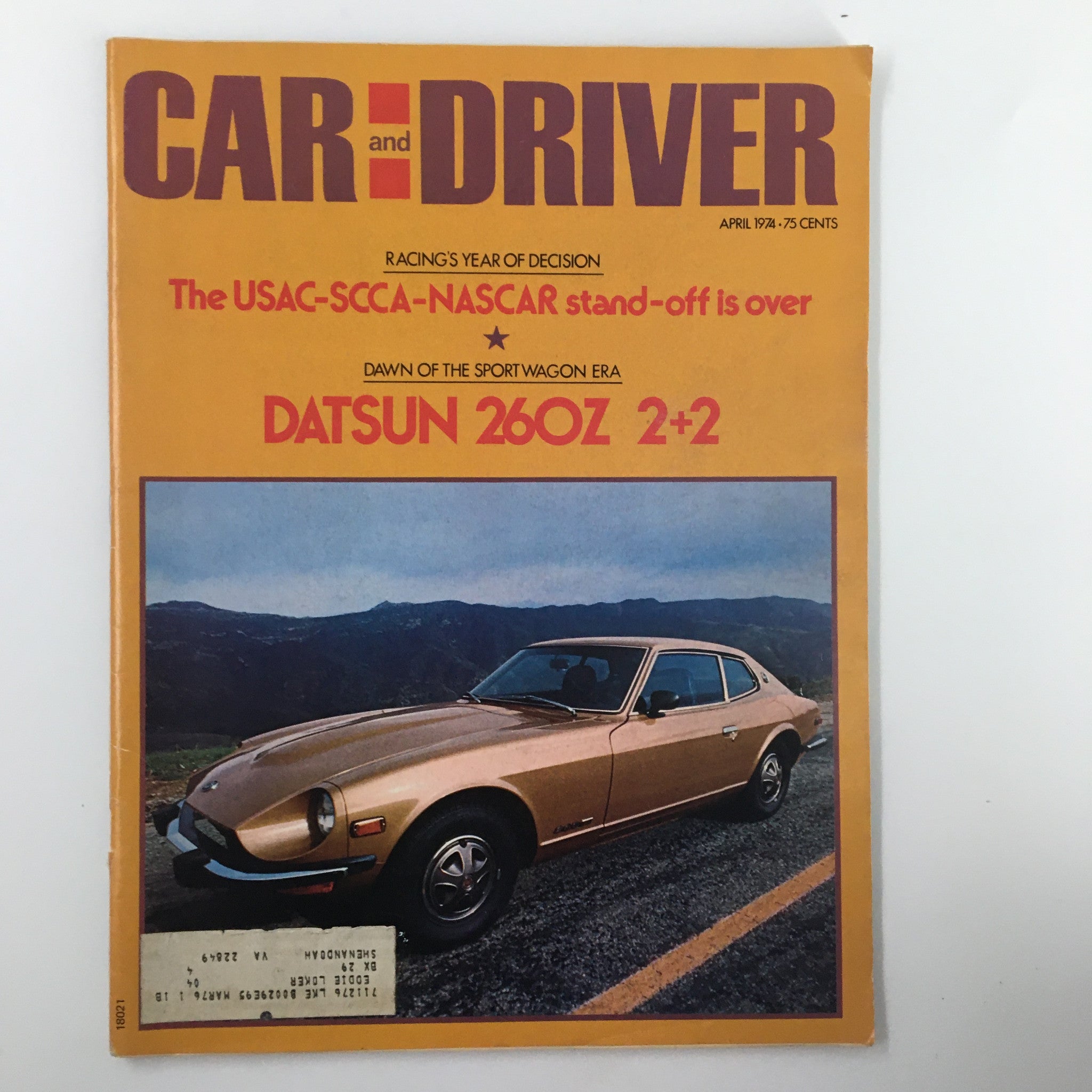 Cover of Car and Driver Magazine, April 1974, featuring the title 'The USAC-SCCA-NASCAR Stand-Off is Over', showcasing a Datsun 260Z 2+2 with a scenic background and a headline on racing developments.