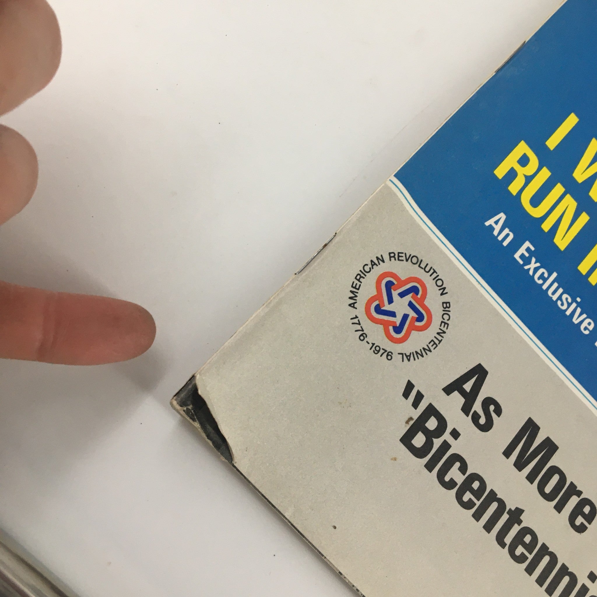 Close-up view of the corner of the US News & World Report Magazine from December 17, 1973, highlighting minor wear and the Bicentennial logo, showcasing its vintage character.