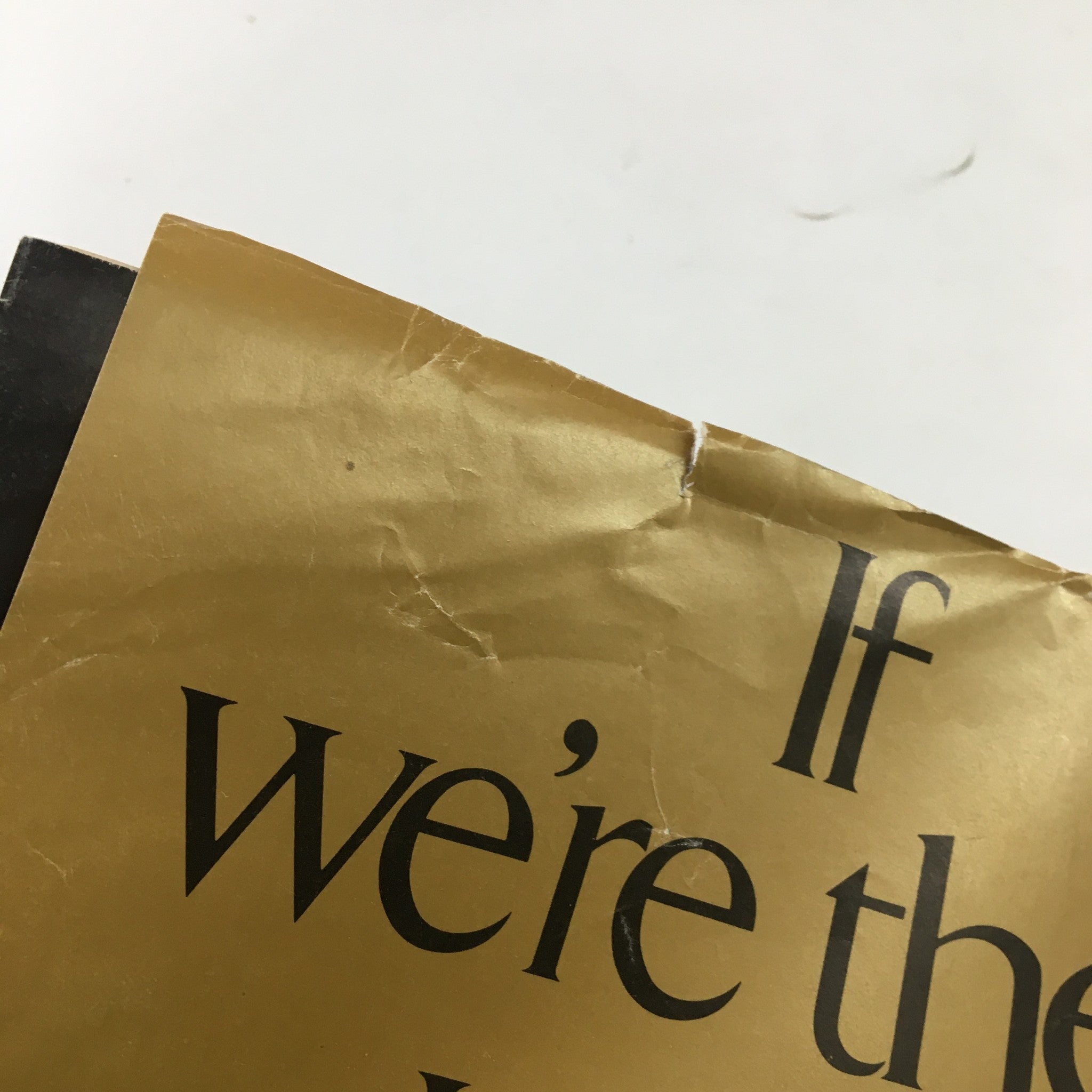 Close-up of the back cover of US News & World Report Magazine, November 5, 1973, featuring a damaged section with the phrase 'If we’re the ...' on a crumpled gold background.