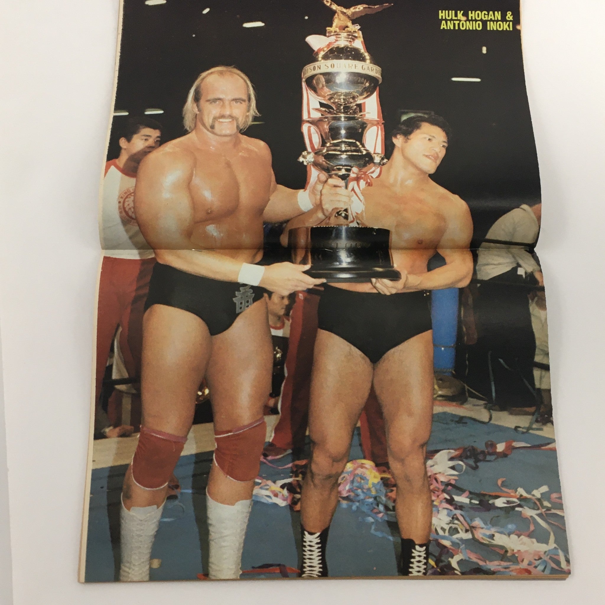 Wrestling Scene Magazine April 1985 #21 cover featuring Hulk Hogan and Antonio Inoki together with a trophy, symbolizing their legendary status in wrestling history.