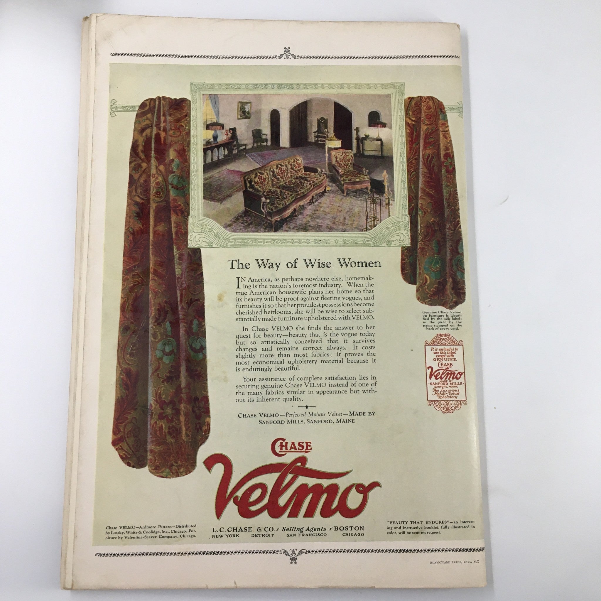 Promotional page in The Spur Magazine December 1 1925 for Velmo fabrics showcasing elegant drapery and furniture, representing design trends of the 1920s.