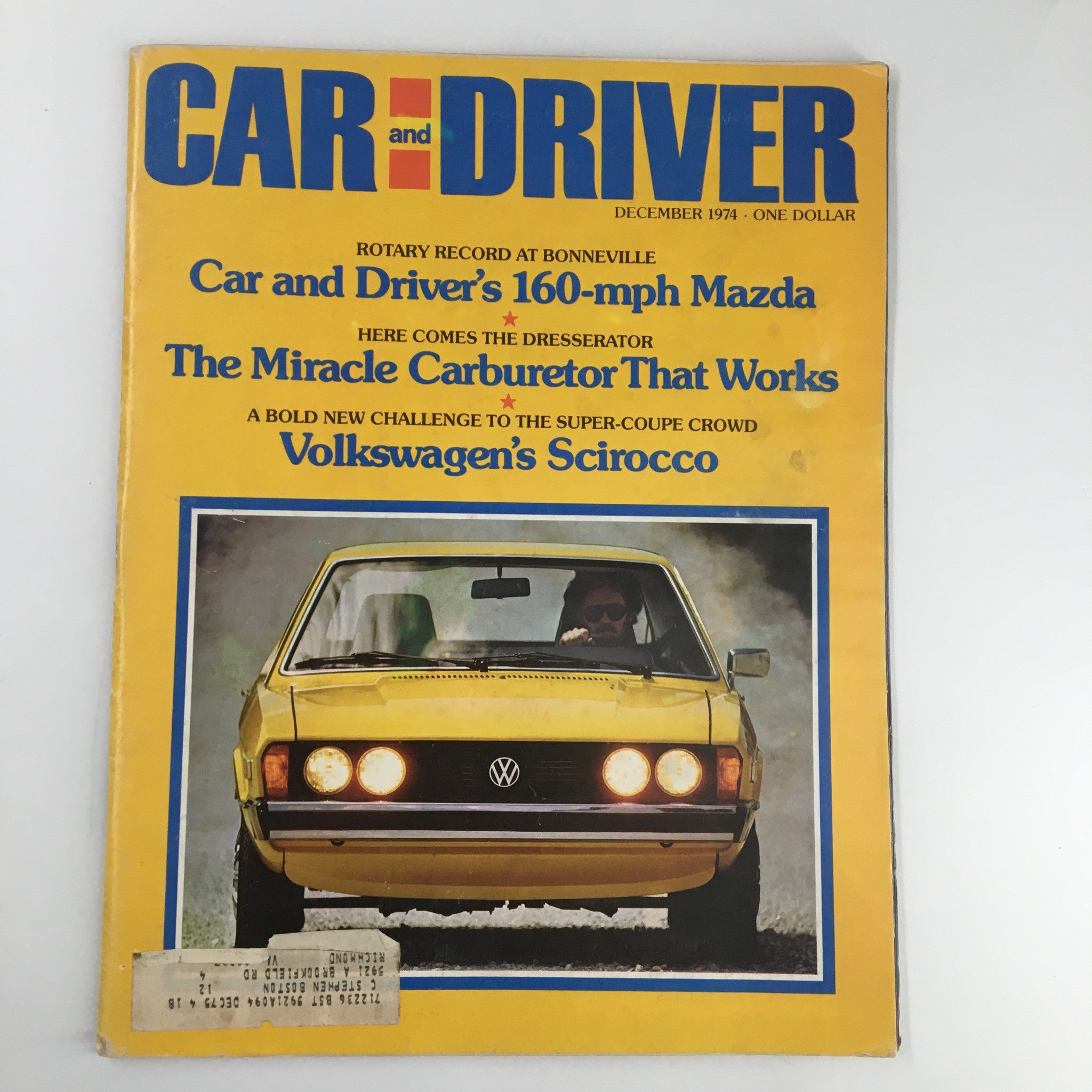 Car and Driver Magazine cover from December 1974 featuring the title 'The Miracle Carburetor That Works'. The cover showcases a yellow Volkswagen Scirocco car with a driver, emphasizing automotive innovations and vintage car culture.