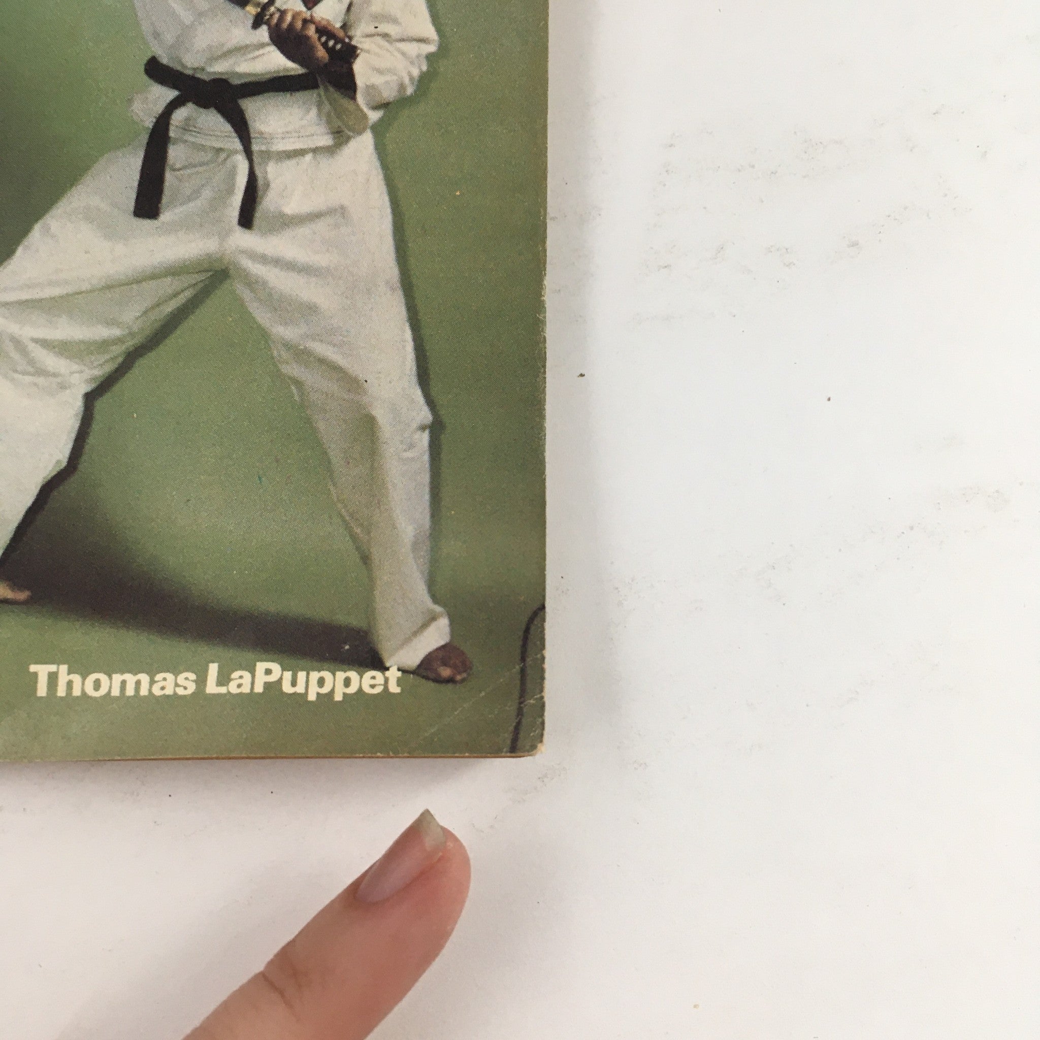 Close-up of Thomas LaPuppet on the cover of Oriental Fighting Arts Magazine, July 1975, demonstrating martial arts techniques.
