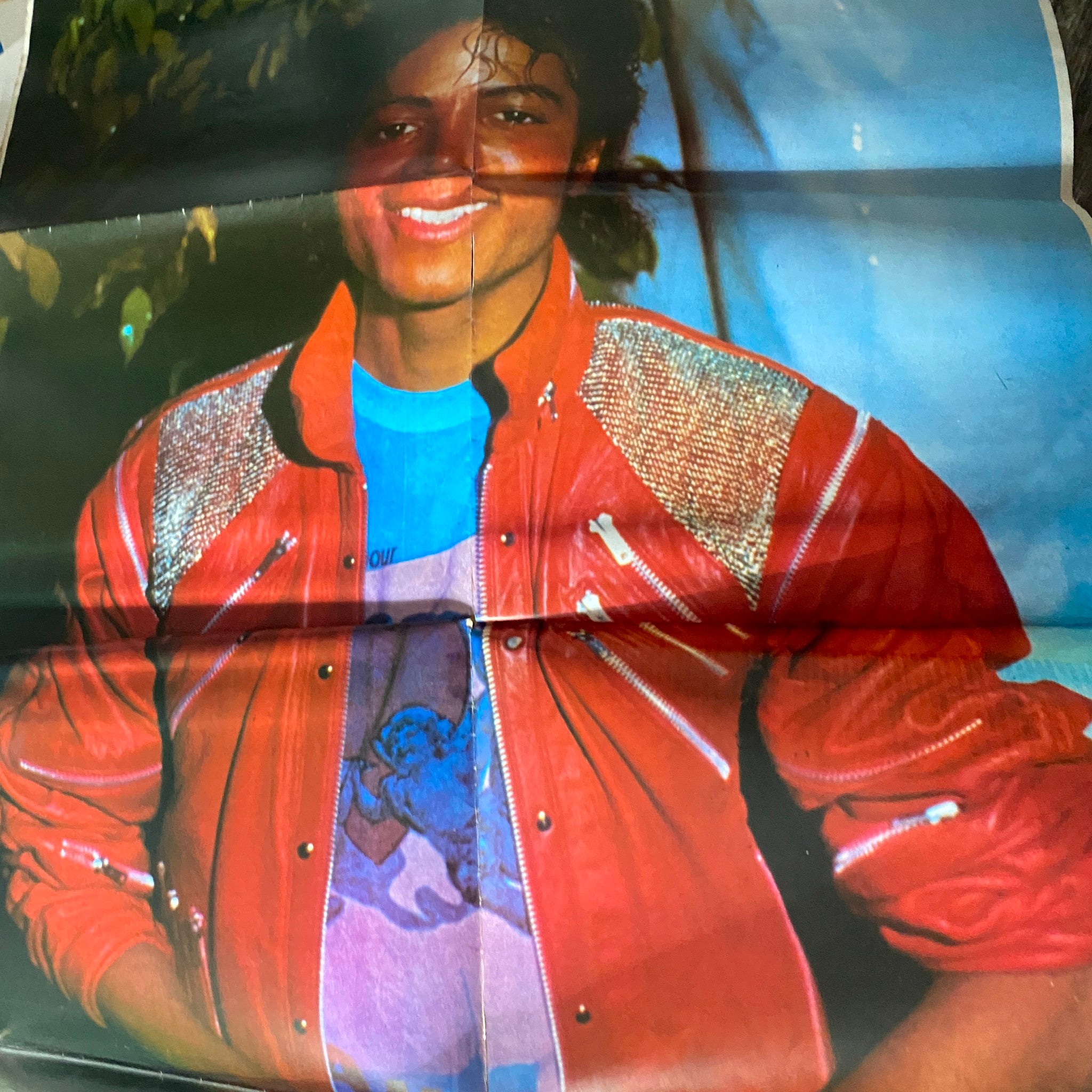 Interior poster from VTG Pop TV Giants Magazine 1984 featuring Michael Jackson wearing a red jacket and a blue t-shirt, smiling widely.