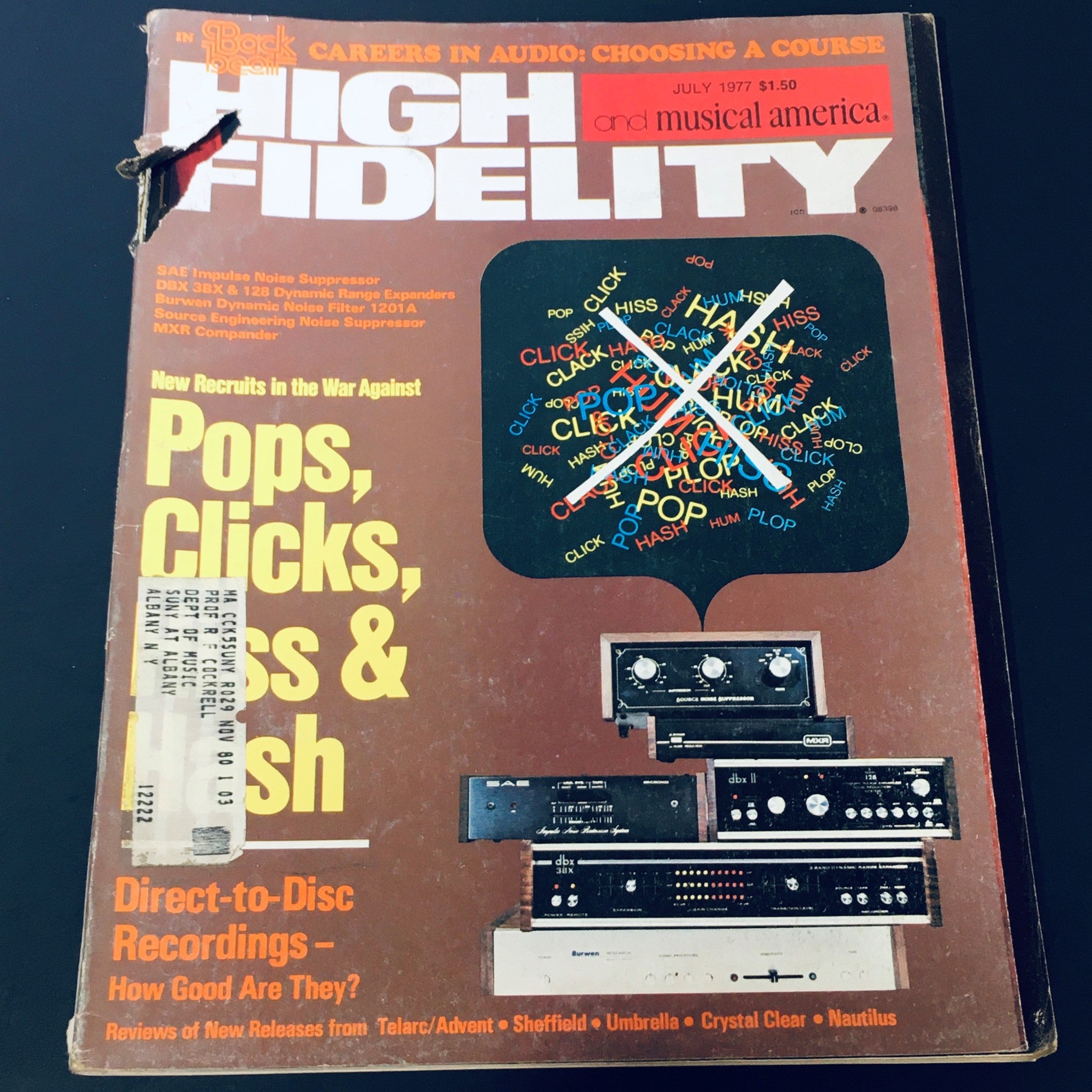 Cover of the VTG High Fidelity Magazine July 1977 featuring the title 'Pops, Clicks, Bass & Hash' with a detailed background discussing sound quality and audio technology. The magazine showcases various audio equipment, adding vintage charm for collectors.