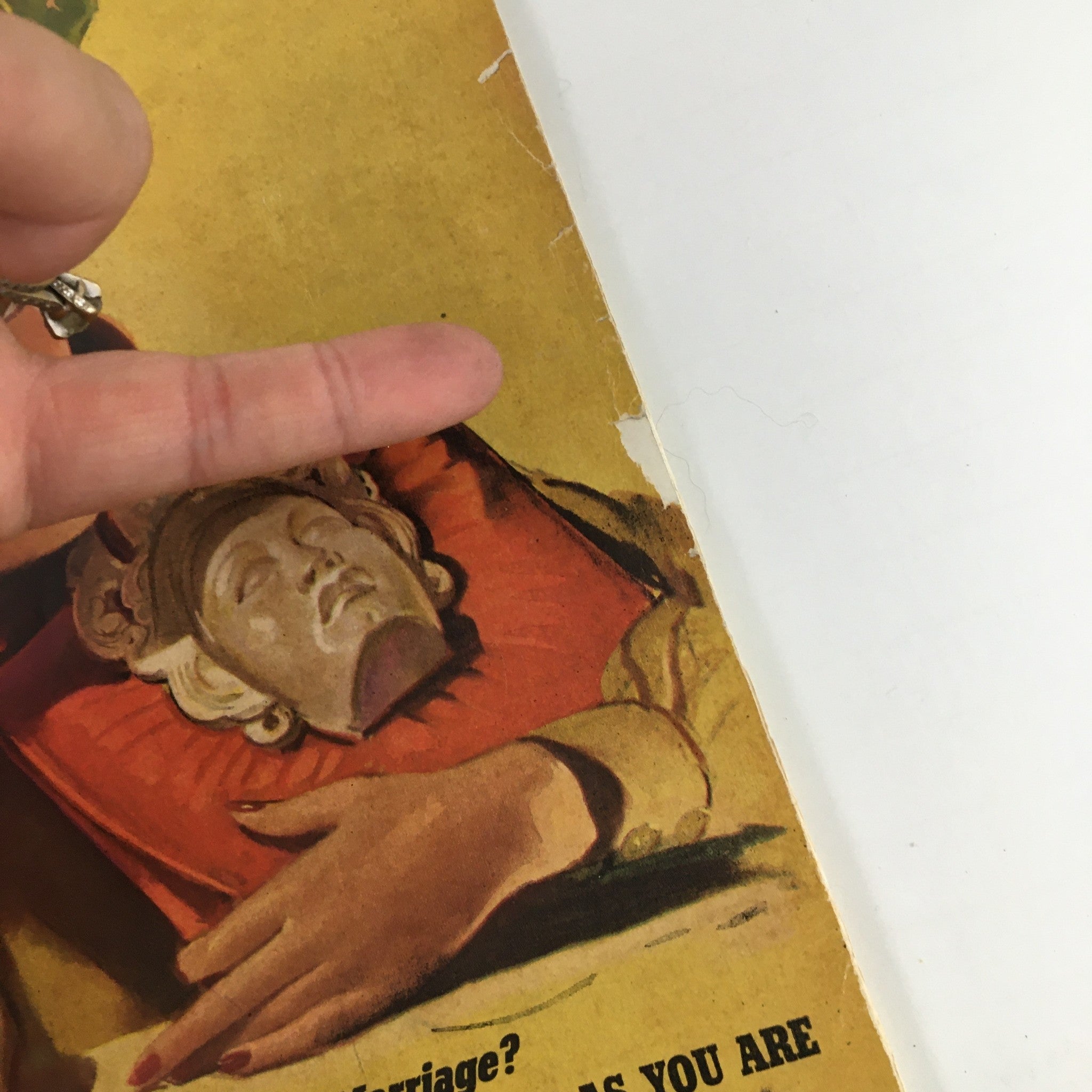 Close-up of the cover of VTG Cosmopolitan Magazine March 1940 highlighting a woman holding a decorative mask.