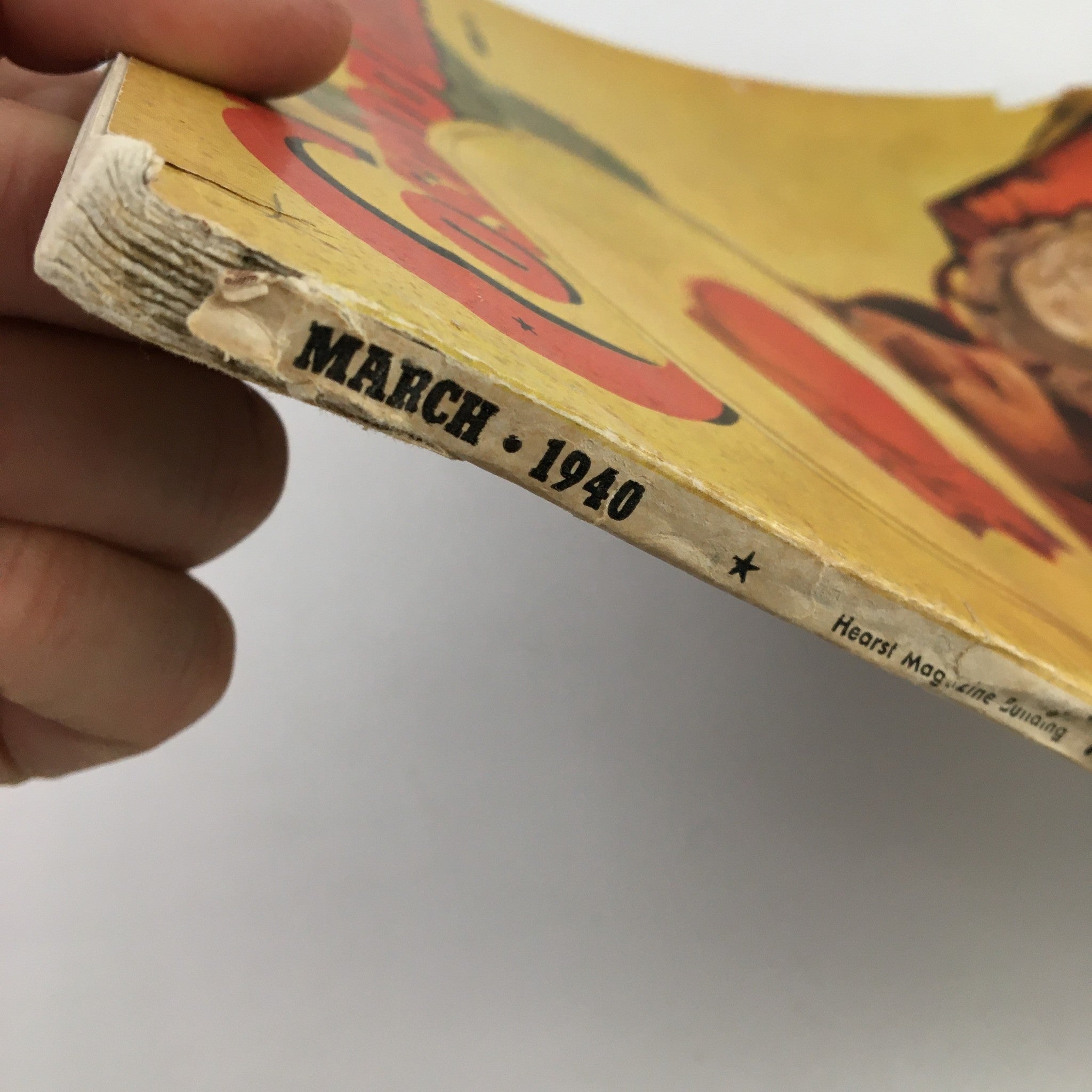 Side view of the spine of VTG Cosmopolitan Magazine March 1940 showing the publication date and branding.
