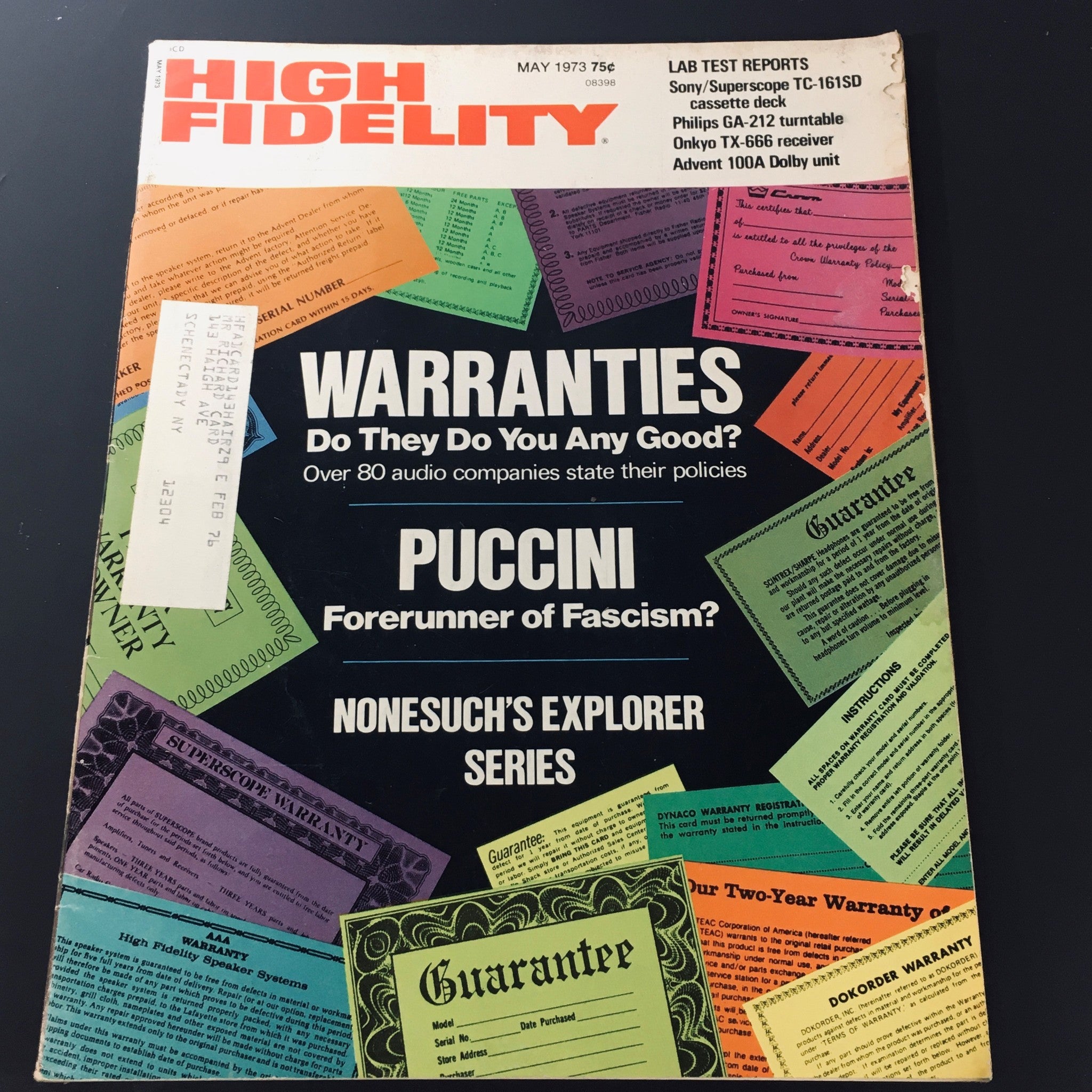 Cover of High Fidelity Magazine from May 1973 featuring the title 'Warranties - Do They Do You Any Good?' and an article on Puccini titled 'Forerunner of Fascism?', showcasing colorful warranty cards.