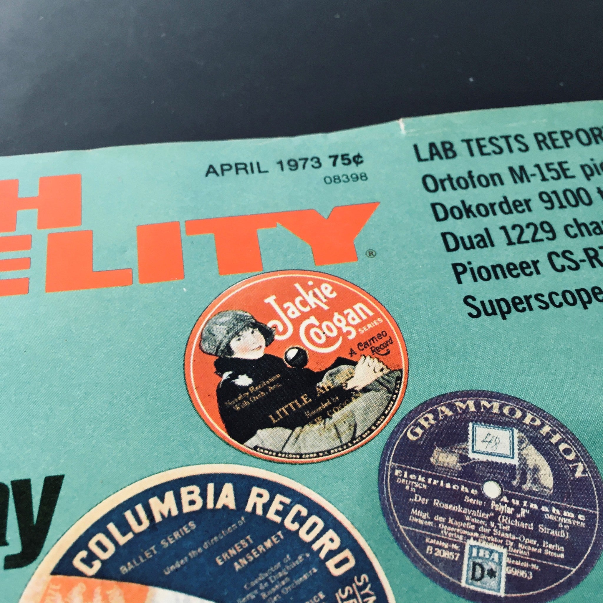 Detail of High Fidelity Magazine April 1973 featuring the label of Jackie Coogan among vintage record graphics, representing music culture.