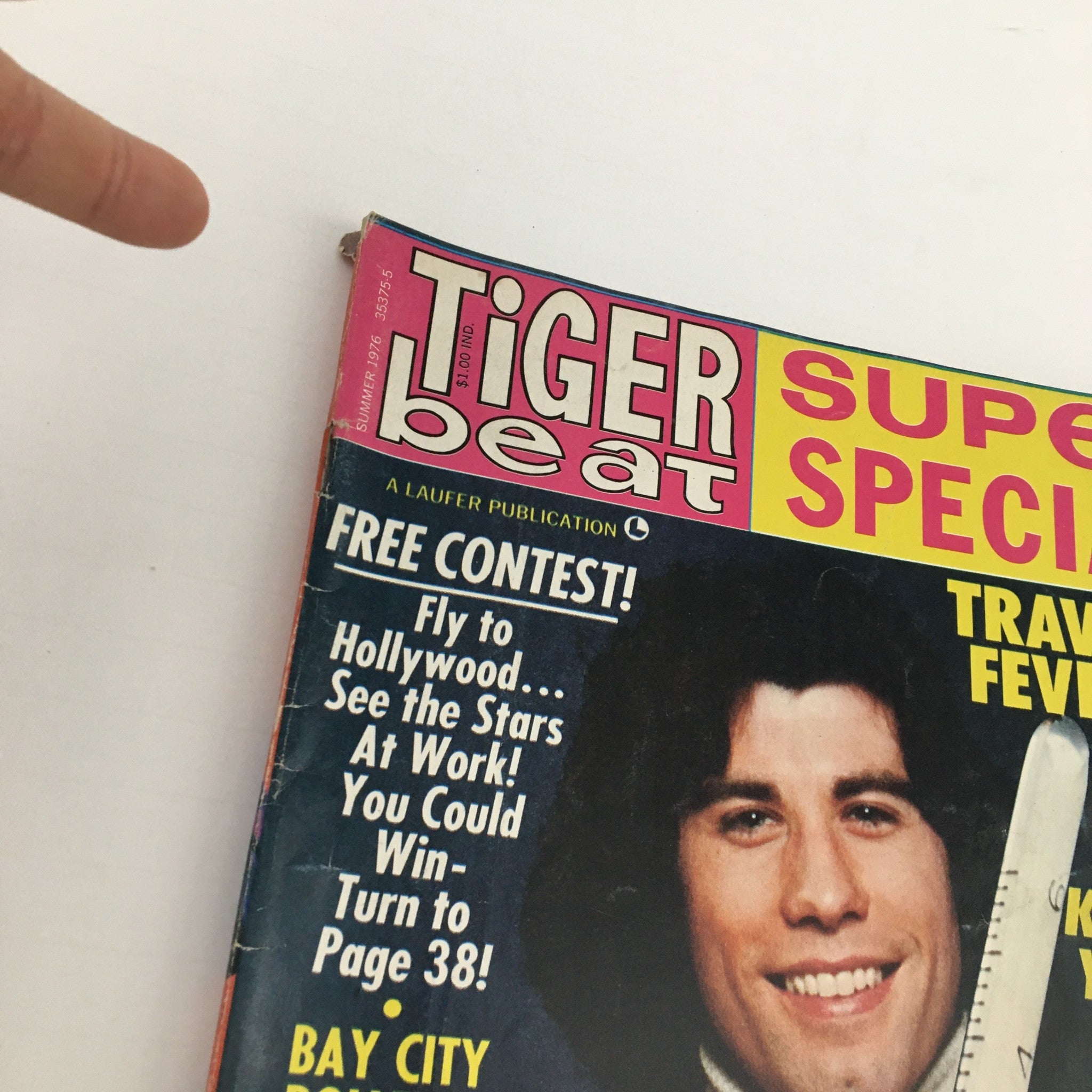 Close-up of the Tiger Beat Magazine Summer 1976 cover highlighting John Travolta, with promotional text about contests and celebrity features.