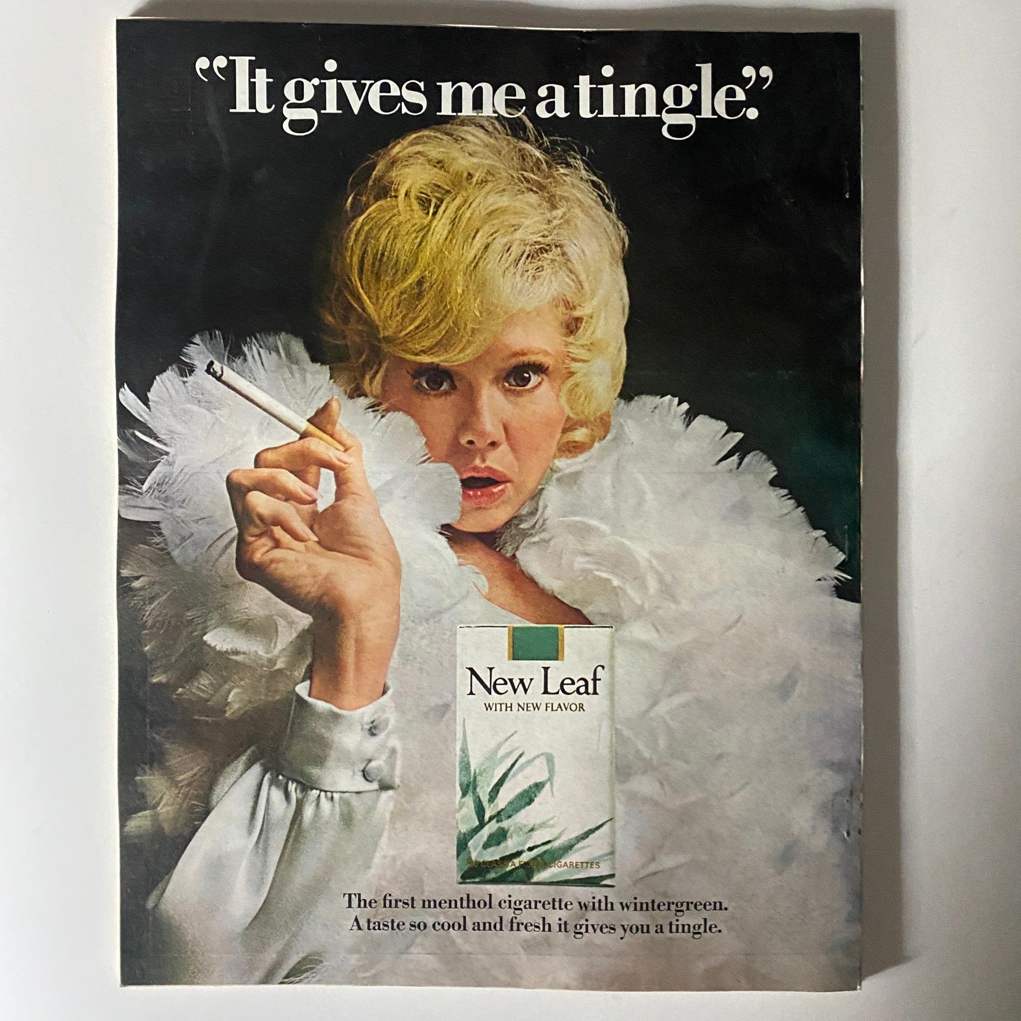 Advertisement from VTG Esquire Magazine February 1971 No. 447, featuring a woman in glamorous attire promoting New Leaf menthol cigarettes, capturing the stylish essence of the 1970s.