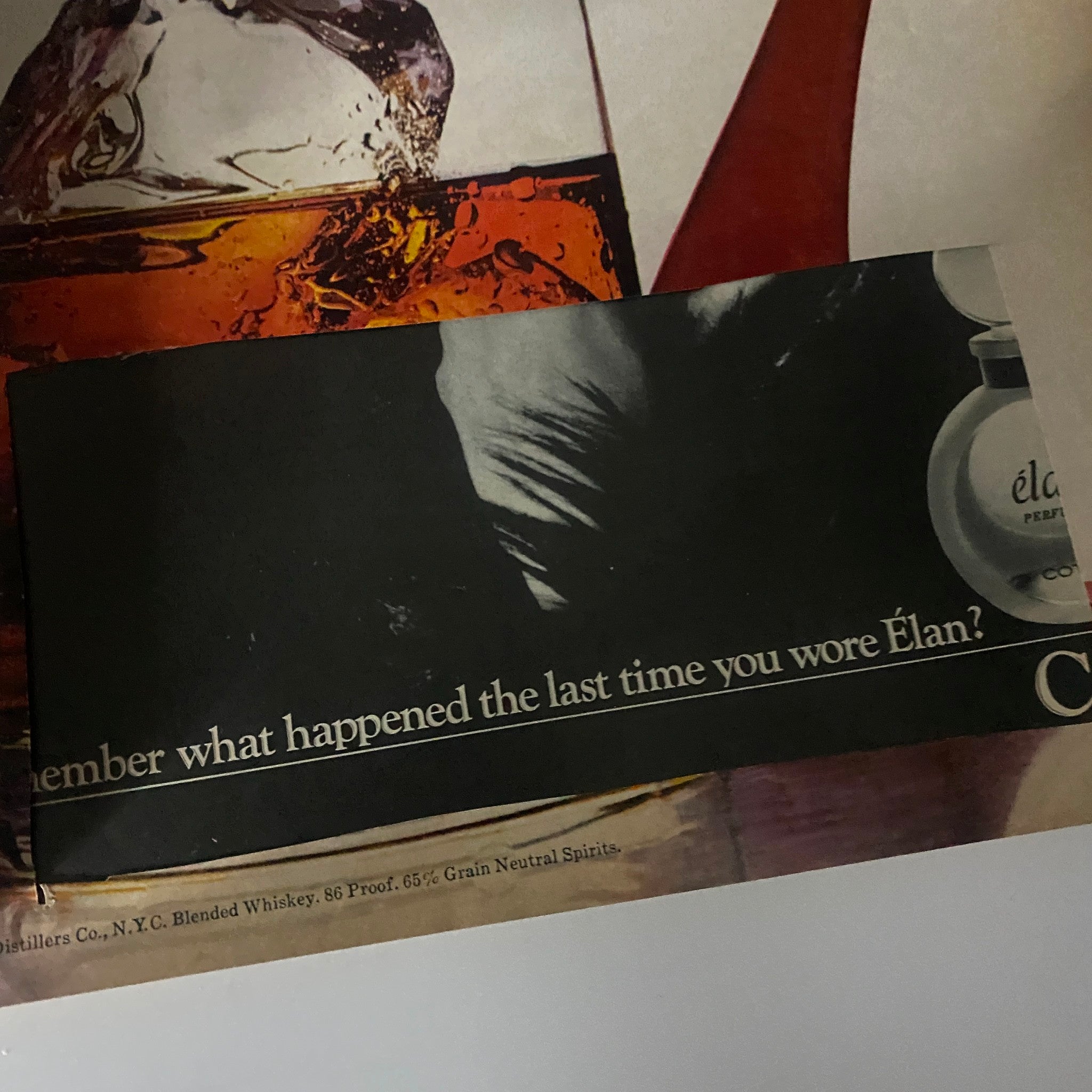 Advertisement page from an unspecified magazine featuring a shadowy figure and a perfume product, titled 'Élan,' with the phrase 'Remember what happened the last time you wore Élan?'