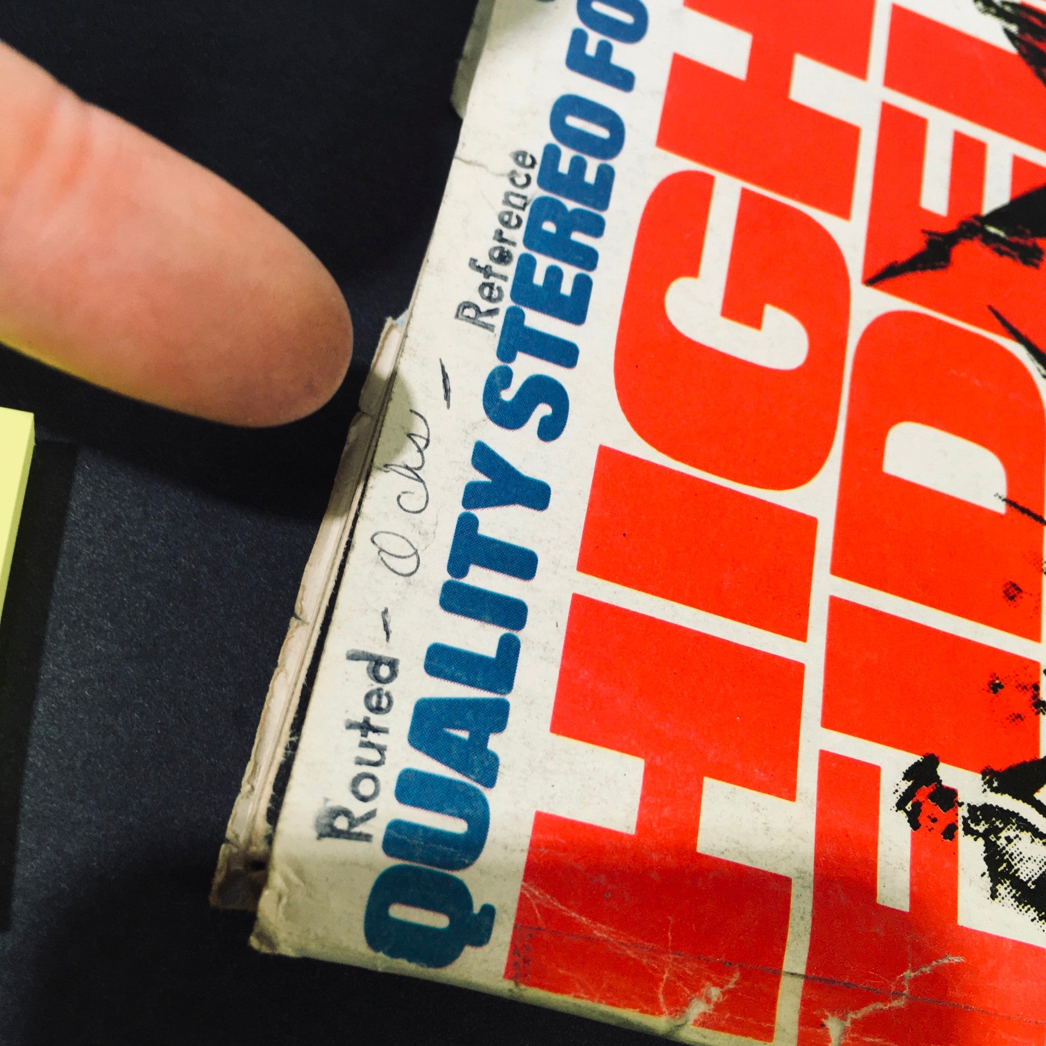 Close-up view of the spine of High Fidelity Magazine July 1976, showing wear and handwritten notes on the cover.