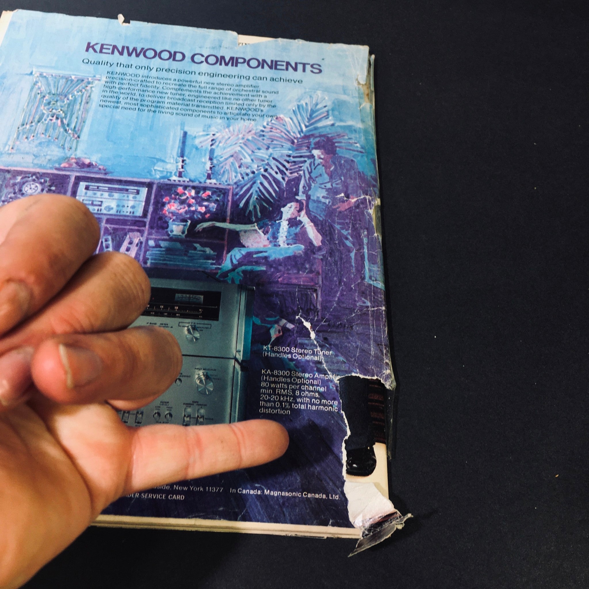 Back cover of High Fidelity Magazine July 1976, showcasing an advertisement for Kenwood audio components with visible wear and damage.