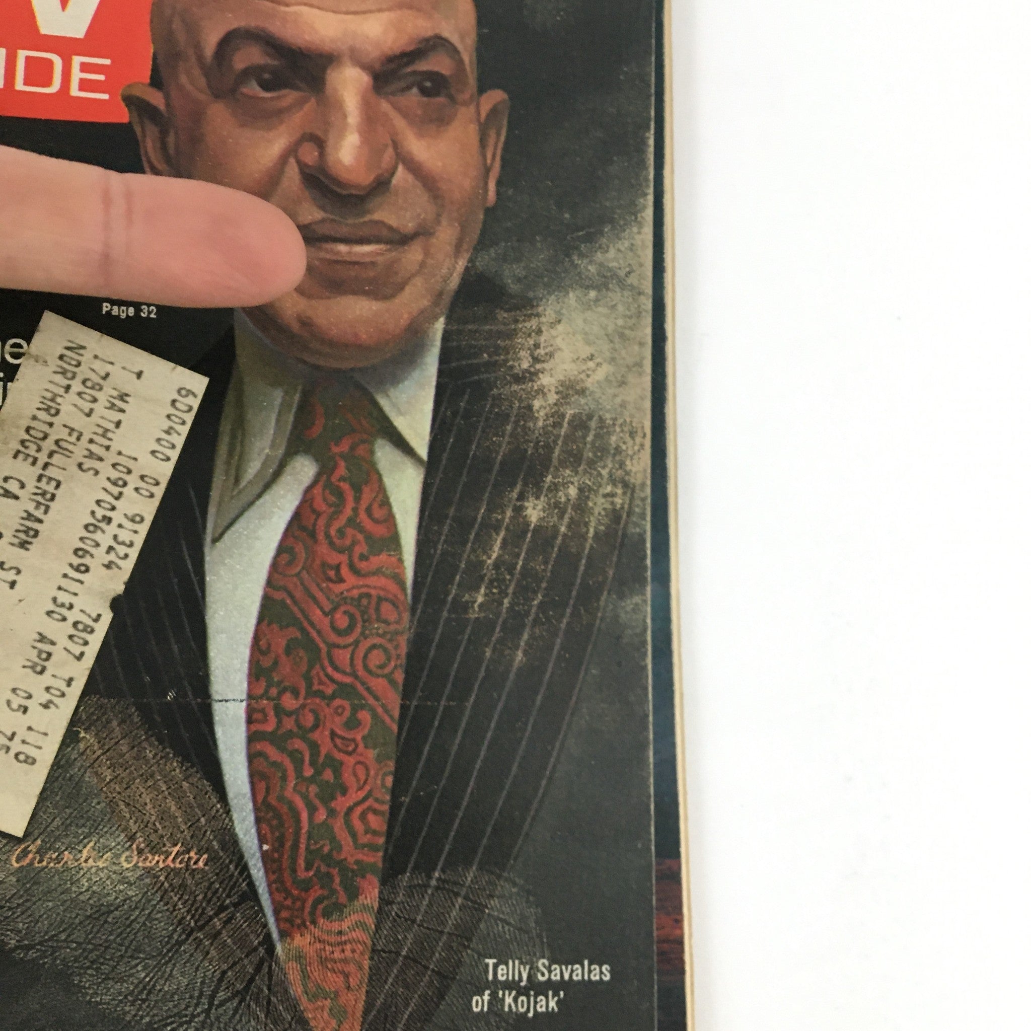 Close-up view of the August 31, 1974 TV Guide Magazine cover featuring Telly Savalas from 'Kojak', highlighting details of Savalas's attire and facial expression.