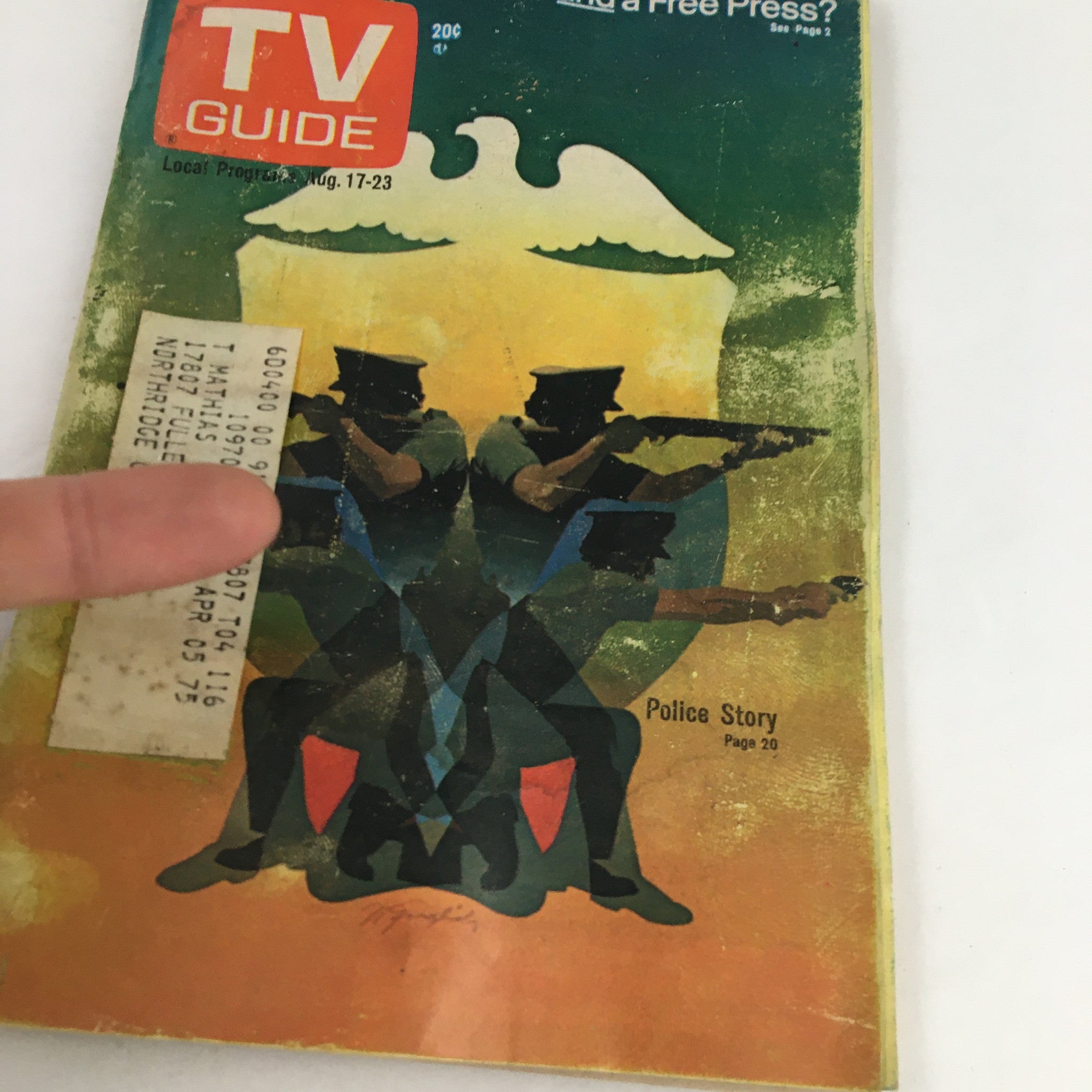 Close-up of the cover of TV Guide Magazine August 17 1974 titled 'Can We Have Fair Trials and a Free Press?' showcasing police officers in action with a colorful background, highlighting the magazine's focus on media and societal issues.