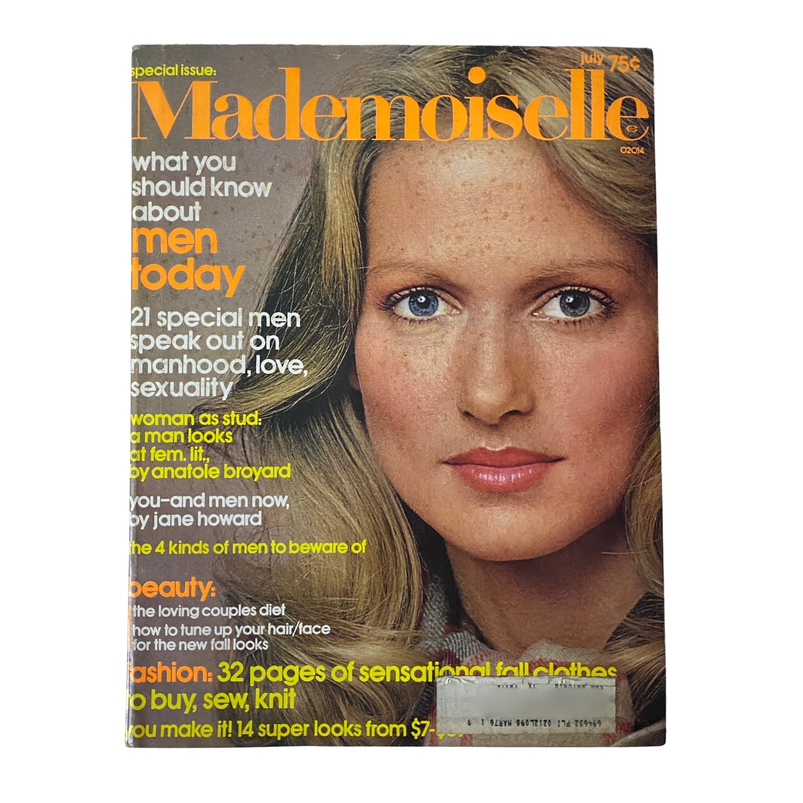 Cover of Mademoiselle Magazine, July 1974, featuring the title 'How to Give a Man a Trim Special Issue.' The cover showcases a striking image of a model with natural makeup and flowing hair, embodying 1970s fashion and beauty. The magazine highlights topics on masculinity, love, and sexuality with special features on grooming and fashion.