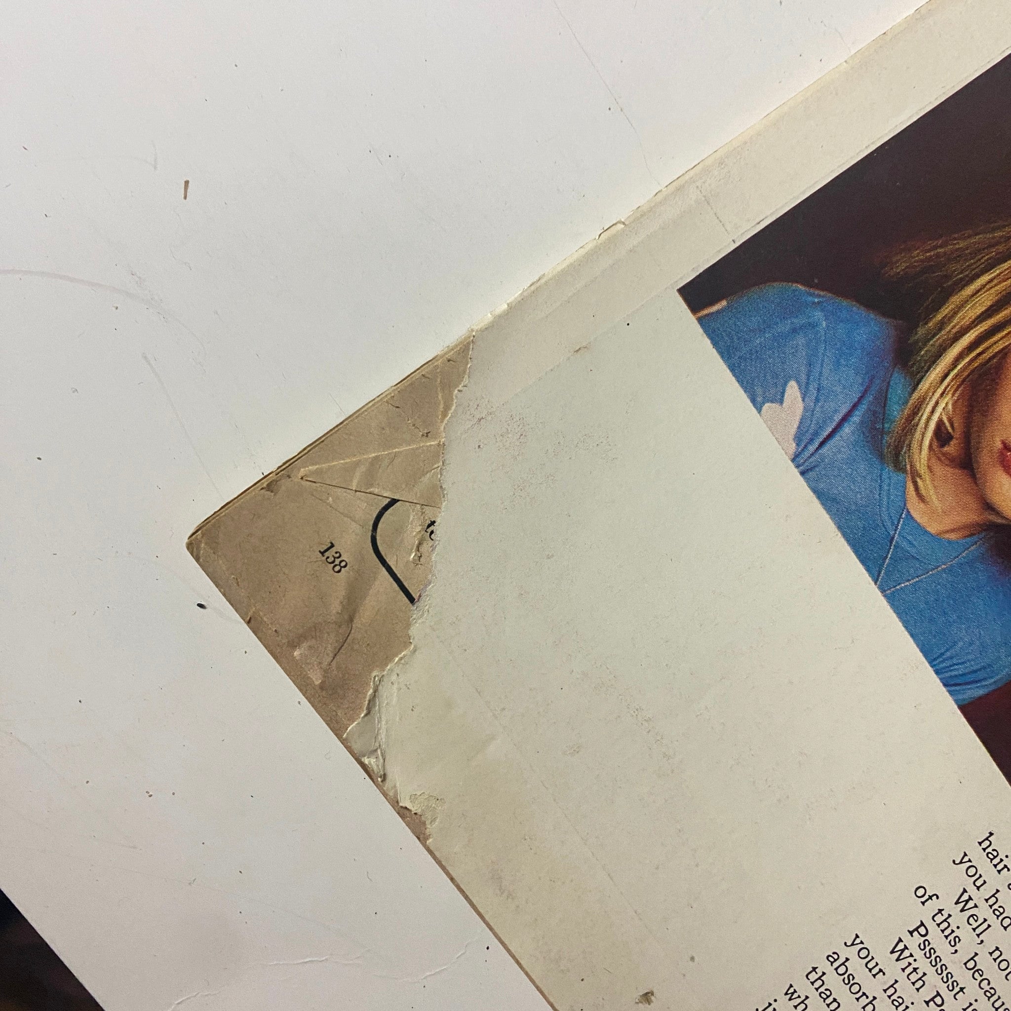 Close-up of the back cover of Mademoiselle Magazine July 1974, showing a tear and details of a hair care product promising transformation.