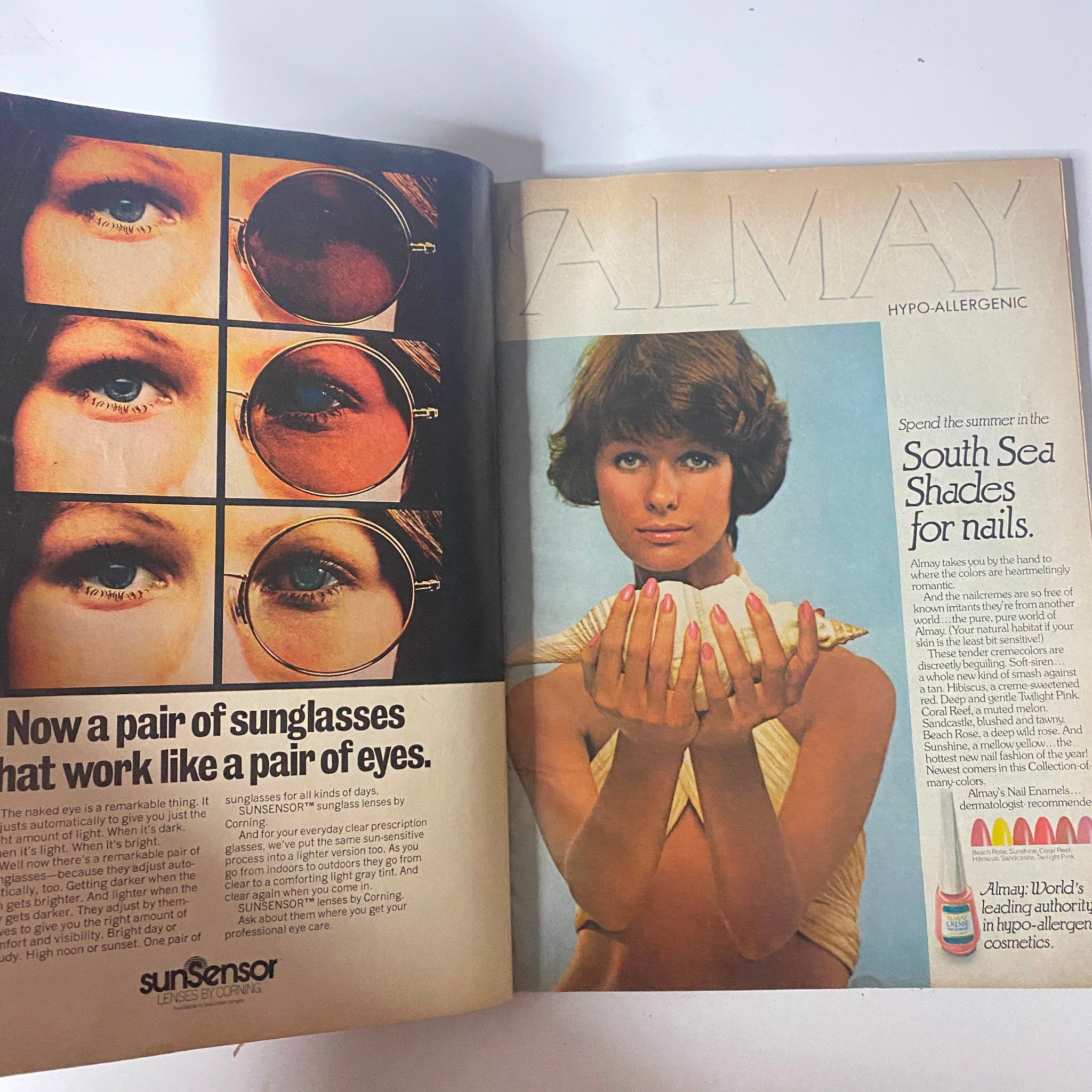 Advertisement from Mademoiselle Magazine, July 1973 promoting Almay cosmetics. The image displays a woman showcasing her nails with text inviting readers to try out summer shades and sunglasses.