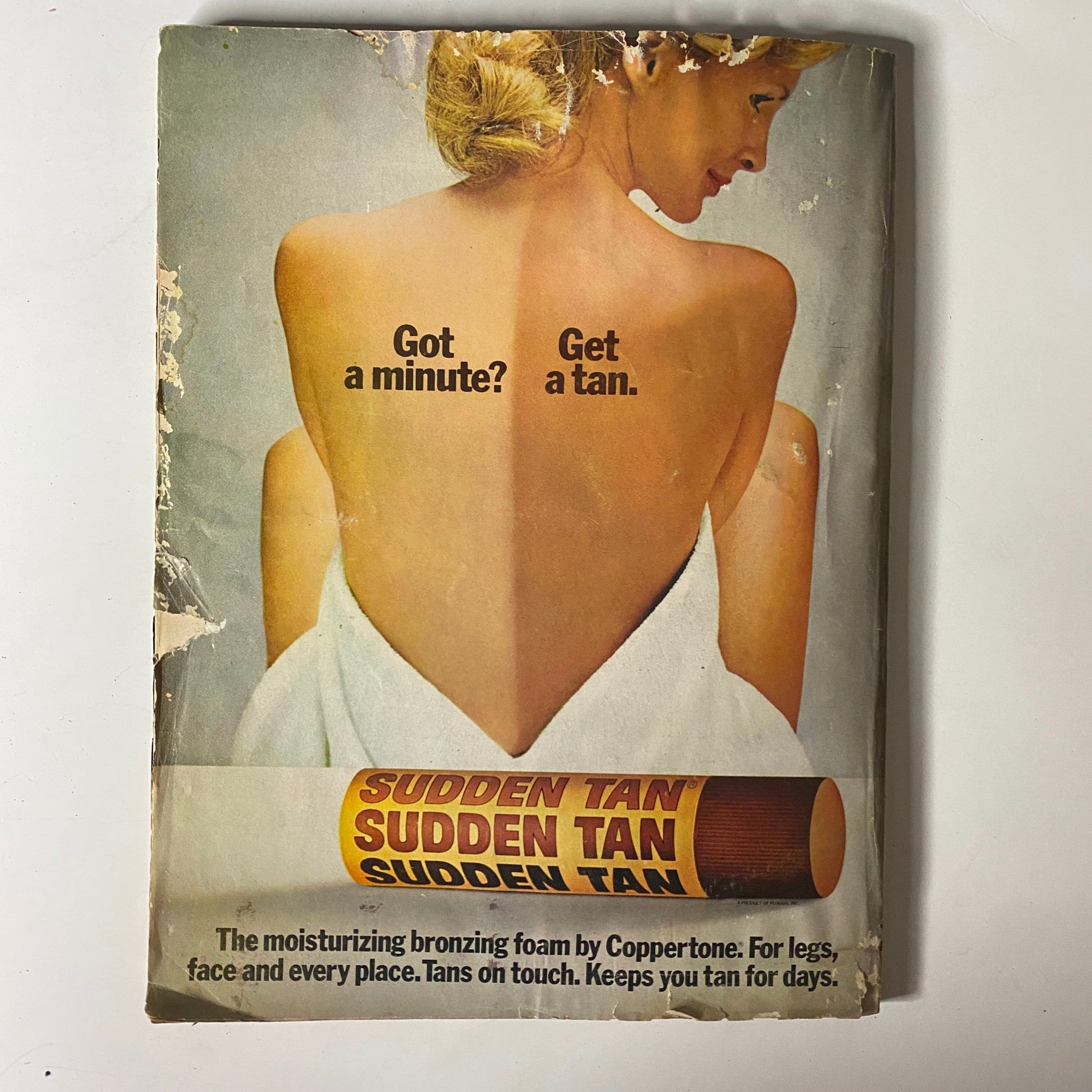 Back cover of Mademoiselle Magazine May 1974 advertising 'Sudden Tan' bronzing foam by Coppertone, featuring a model showcasing sun-kissed skin in a stylish pose.
