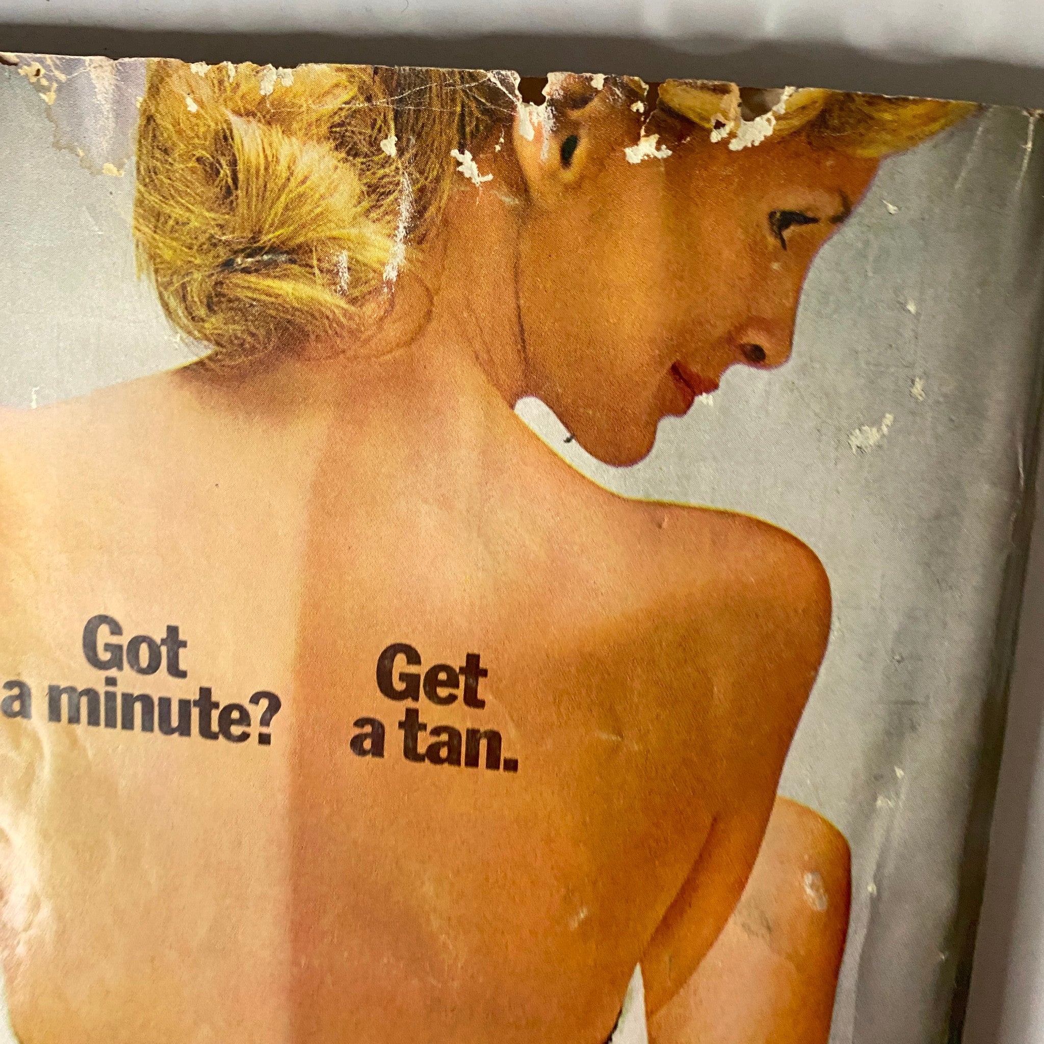 Cover detail from Mademoiselle Magazine May 1974 featuring a woman with tan lines and the text 'Got a minute? Get a tan.' highlighting 1970s beauty standards.