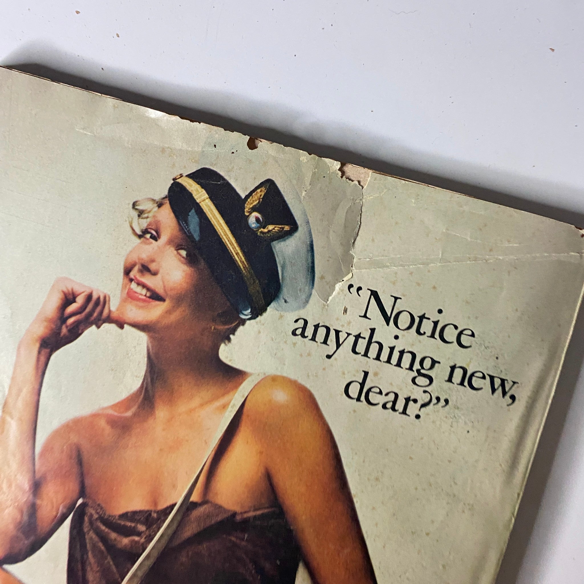 Close-up view of the back cover from Mademoiselle Magazine December 1972 featuring a smiling model with a hat saying 'Notice anything new, dear?' highlighting Jaclyn, Inc. brand.