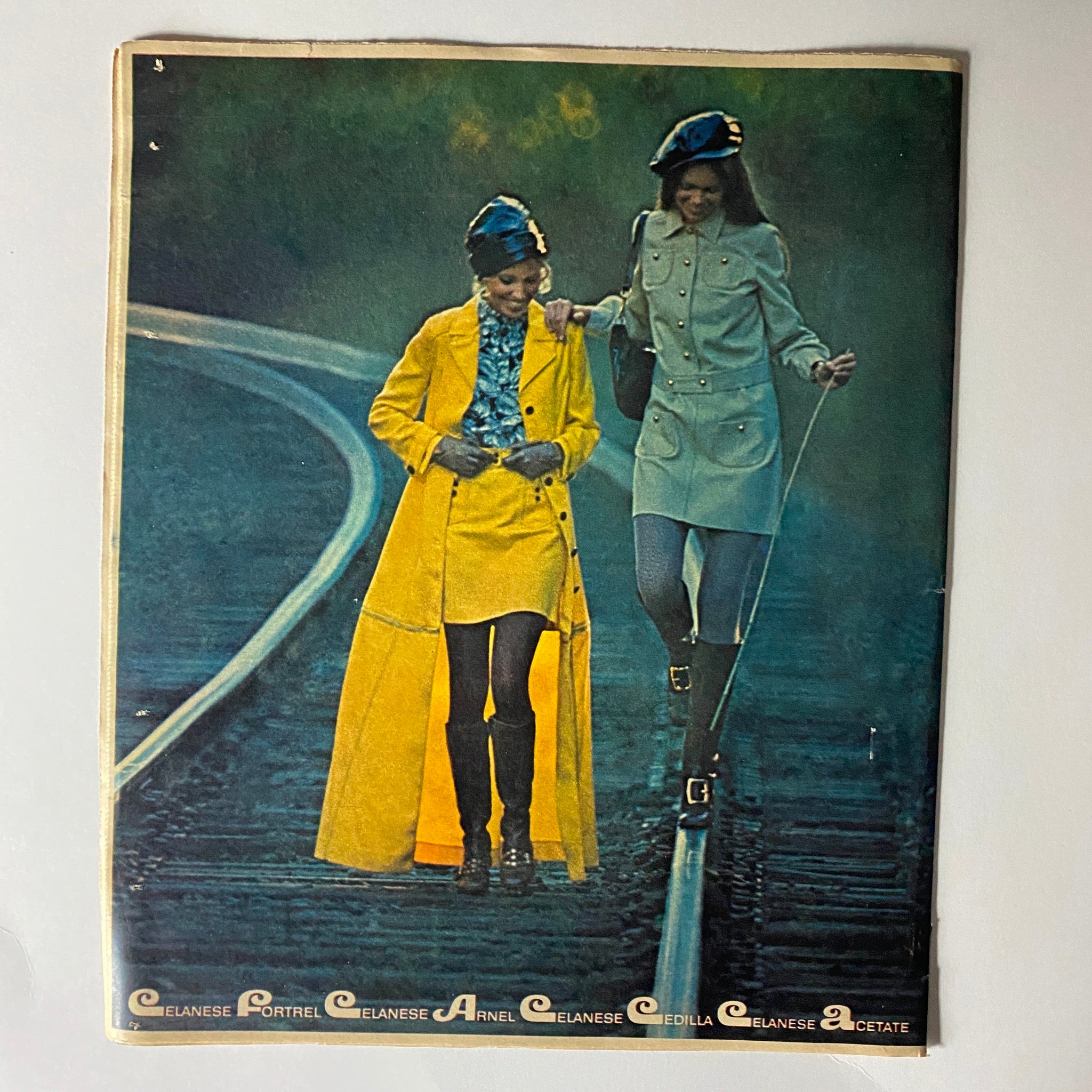 The New York Times Magazine January 4 1970 page showing models in trendy Celanese attire, one in a yellow coat and another in a stylish ensemble, walking along a railway.