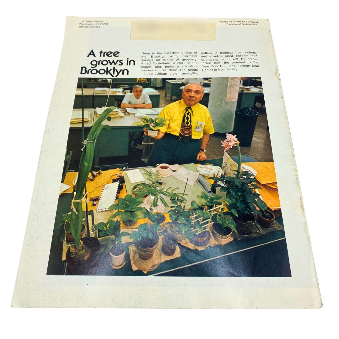 Image of the VTG Postal Life Magazine July - August 1973 featuring an article titled 'A tree grows in Brooklyn' with a postal employee engaging with plants in a lively office setting.