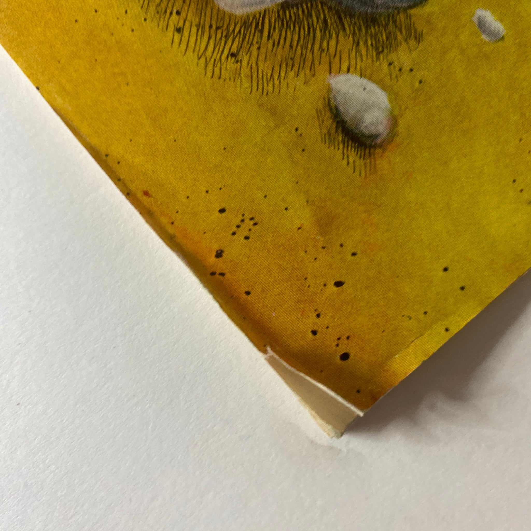 Close-up image of the corner of The New Yorker January 13, 1973 magazine, highlighting a small rip yet showcasing the vibrant yellow background of the cover art.