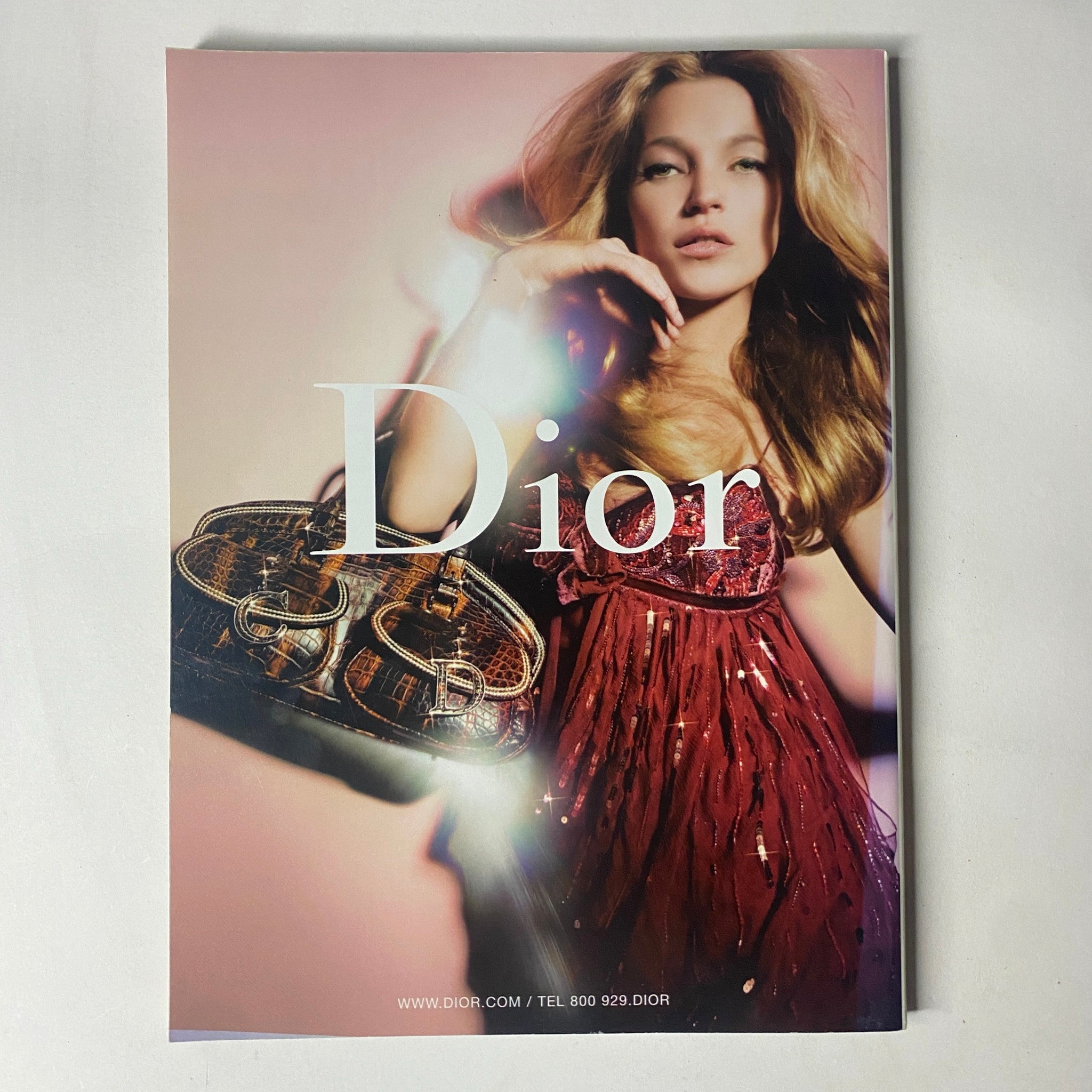 Harper's Bazaar Magazine October 2005 cover showcasing a high-fashion Dior advertisement, featuring a model in a glamorous outfit with a designer handbag.