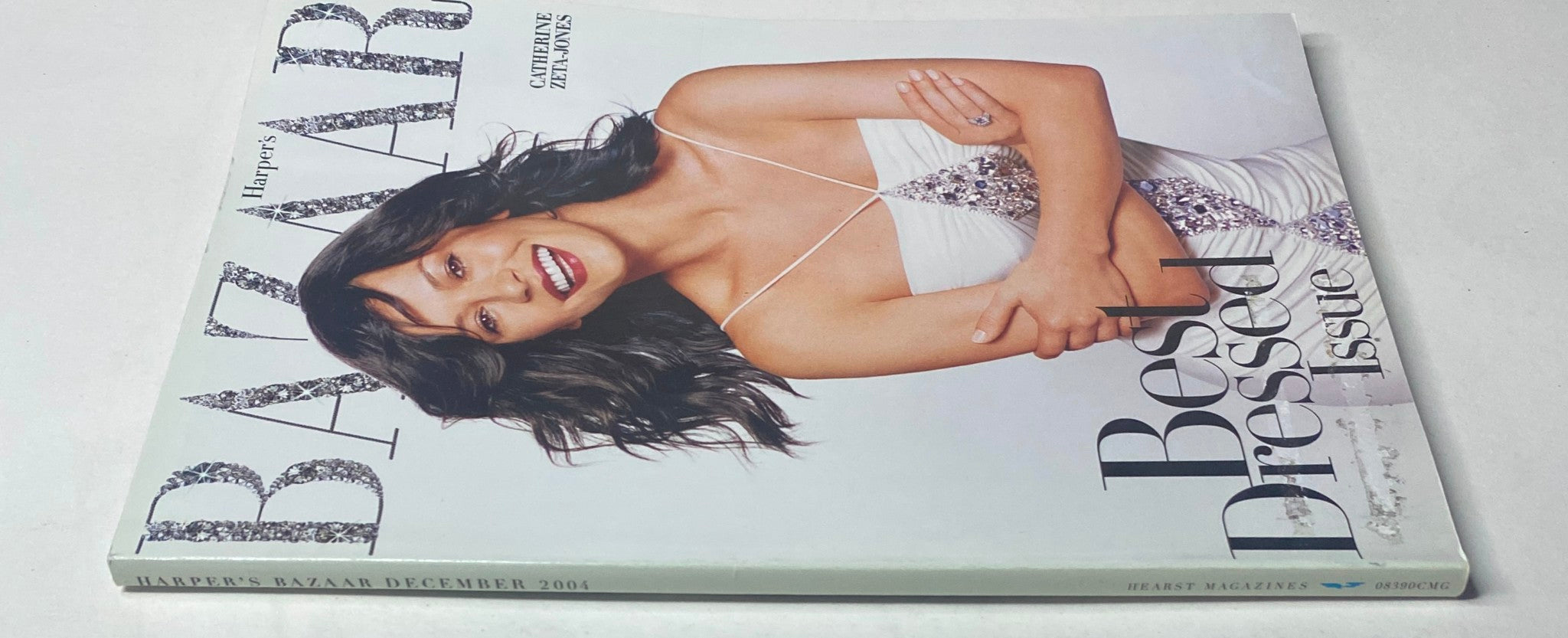 Harper's Bazaar December 2004 cover image featuring Catherine Zeta-Jones, highlighting the Best Dressed Issue with her glamorous hairstyle and sparkling outfit.