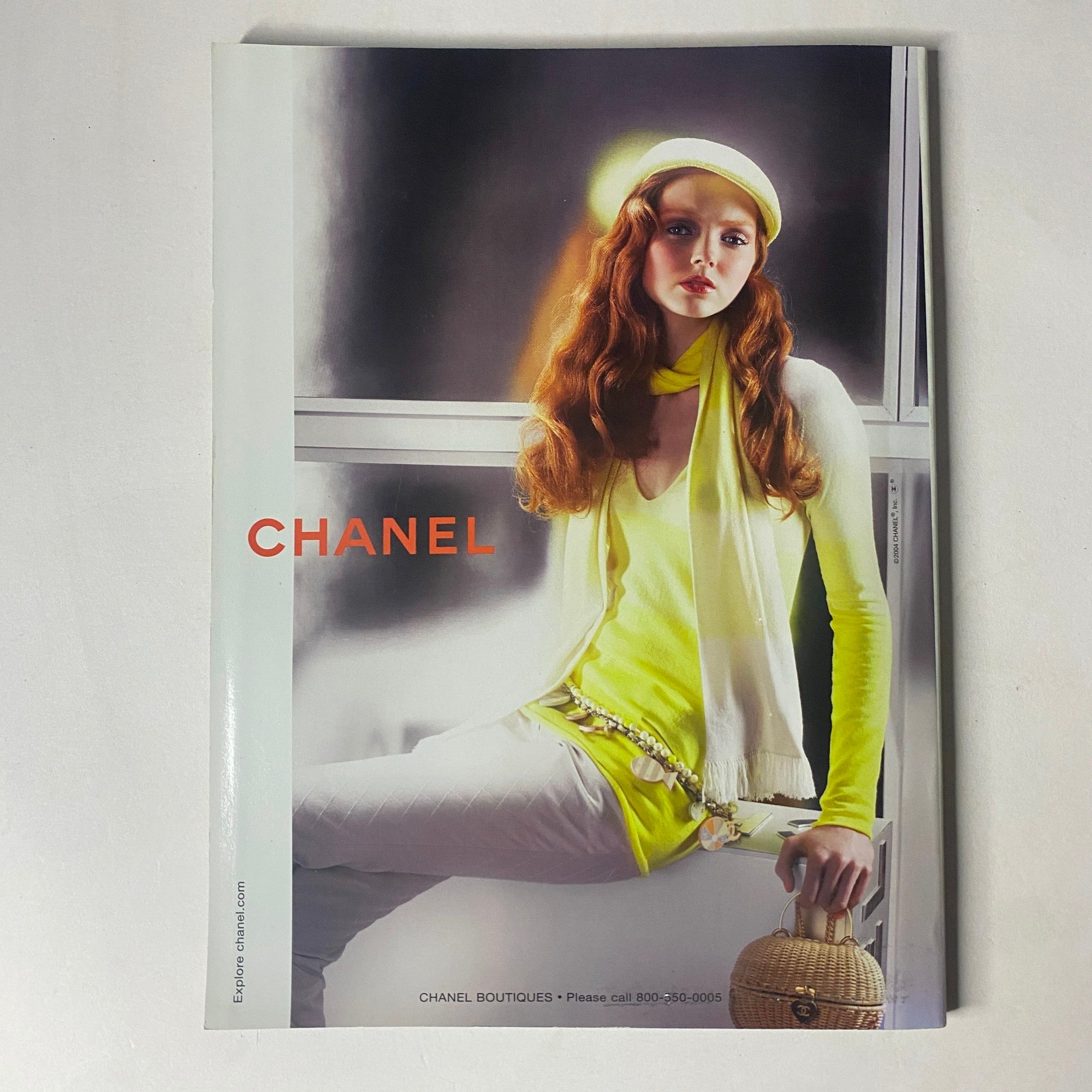 Harper's Bazaar December 2004 magazine spread featuring a model in a vibrant Chanel outfit and accessories, styled for the holiday season.