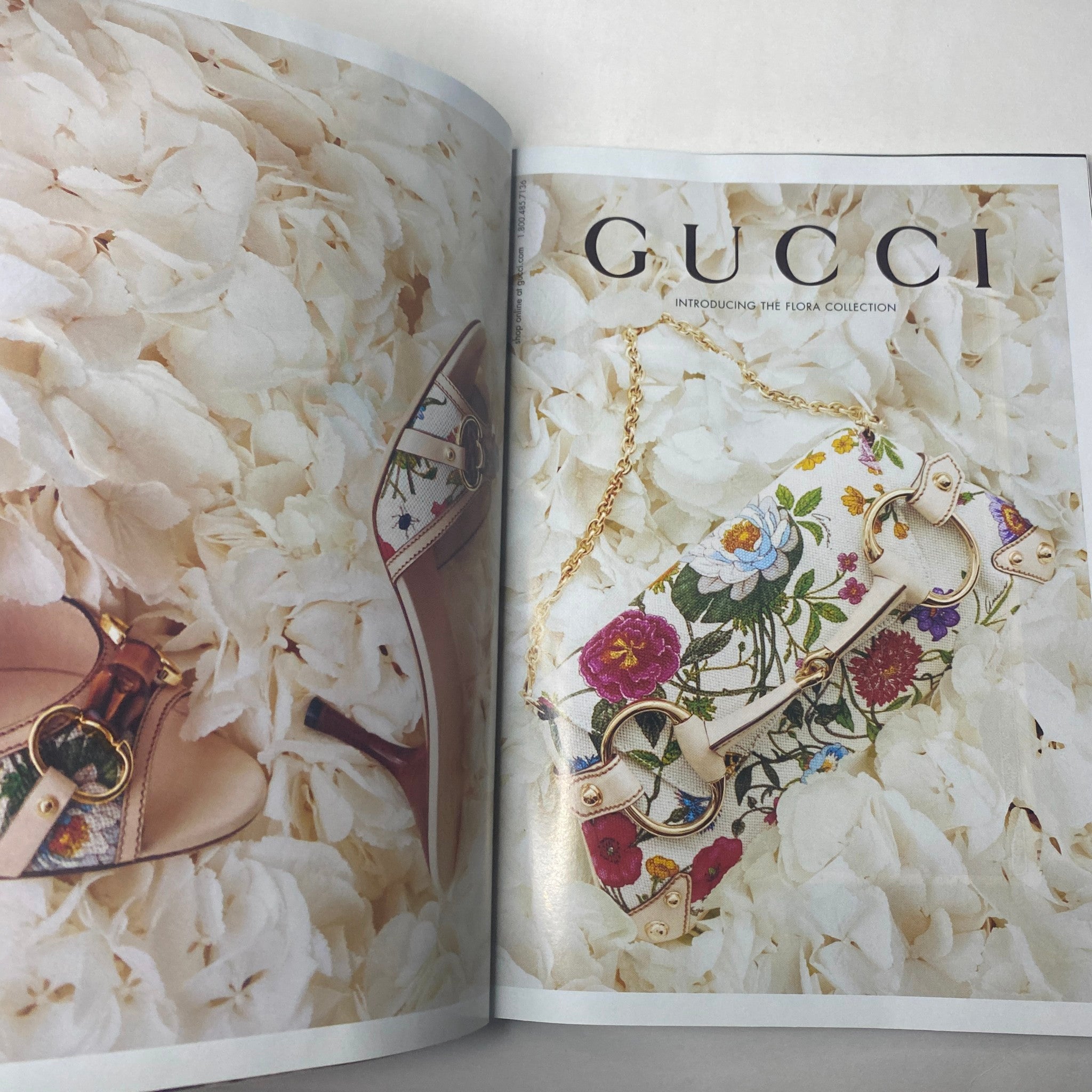 Gucci floral collection advertisement featuring a handbag and high-heeled sandals on a bed of flower petals, included in Harper's Bazaar Magazine January 2005 Scarlett Johansson Cover.