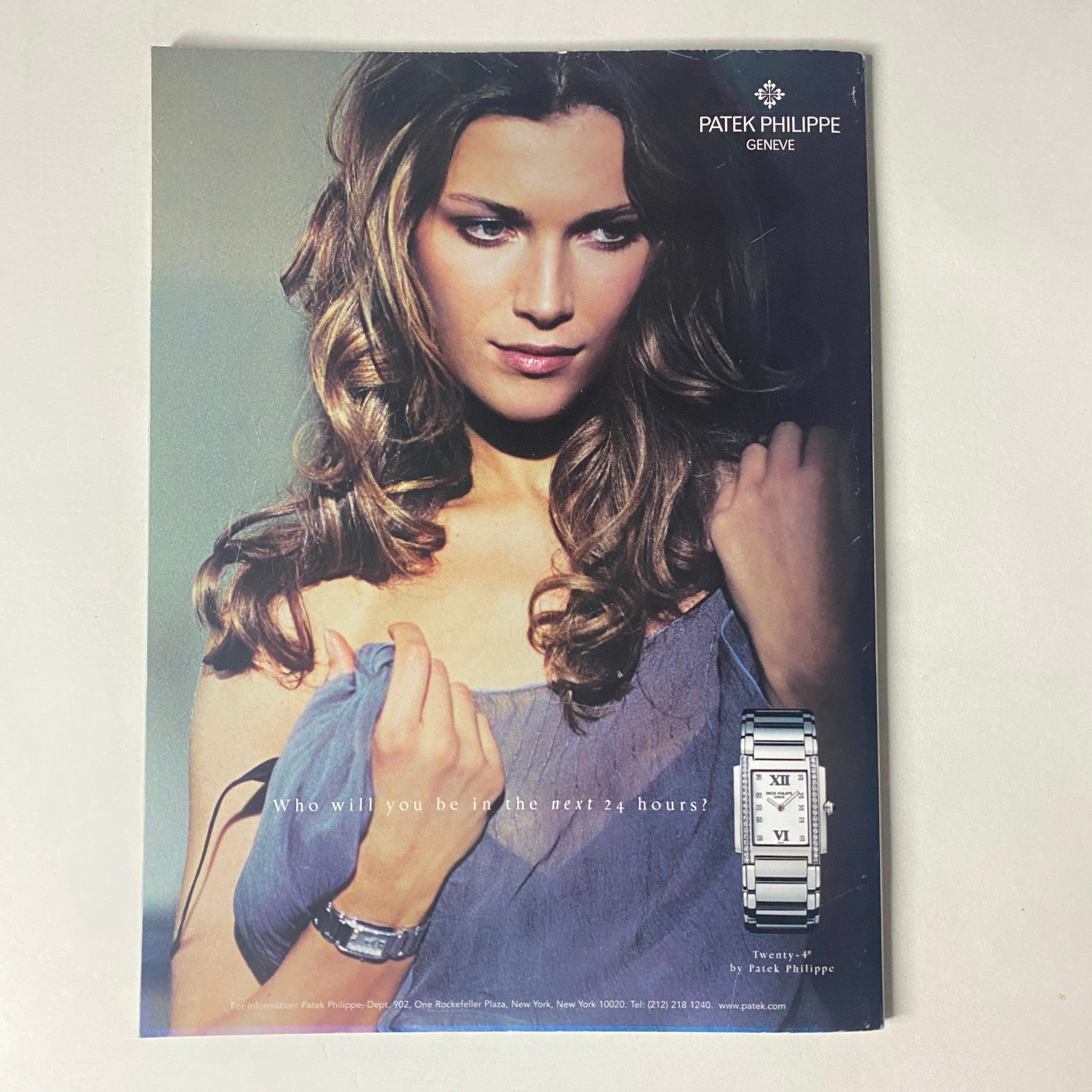 Patek Philippe advertisement displaying a glamorous model with elegant wristwatch and long, styled hair, featured in Harper's Bazaar Magazine January 2005 Scarlett Johansson Cover.