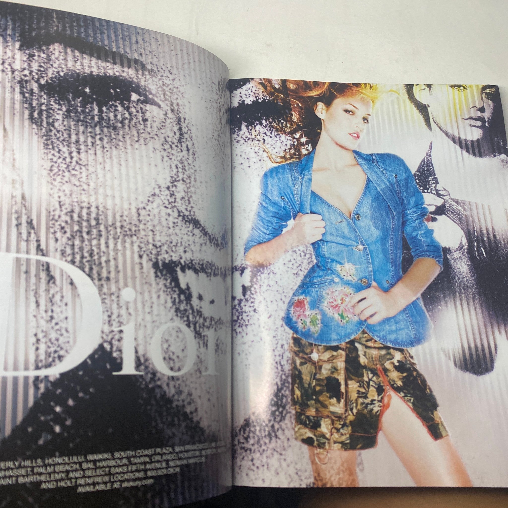 Fashion editorial spread from Harper's Bazaar Magazine February 2005 showcasing a model in a blue denim blazer with floral accents, set against a dynamic Dior backdrop, highlighting bold style choices.