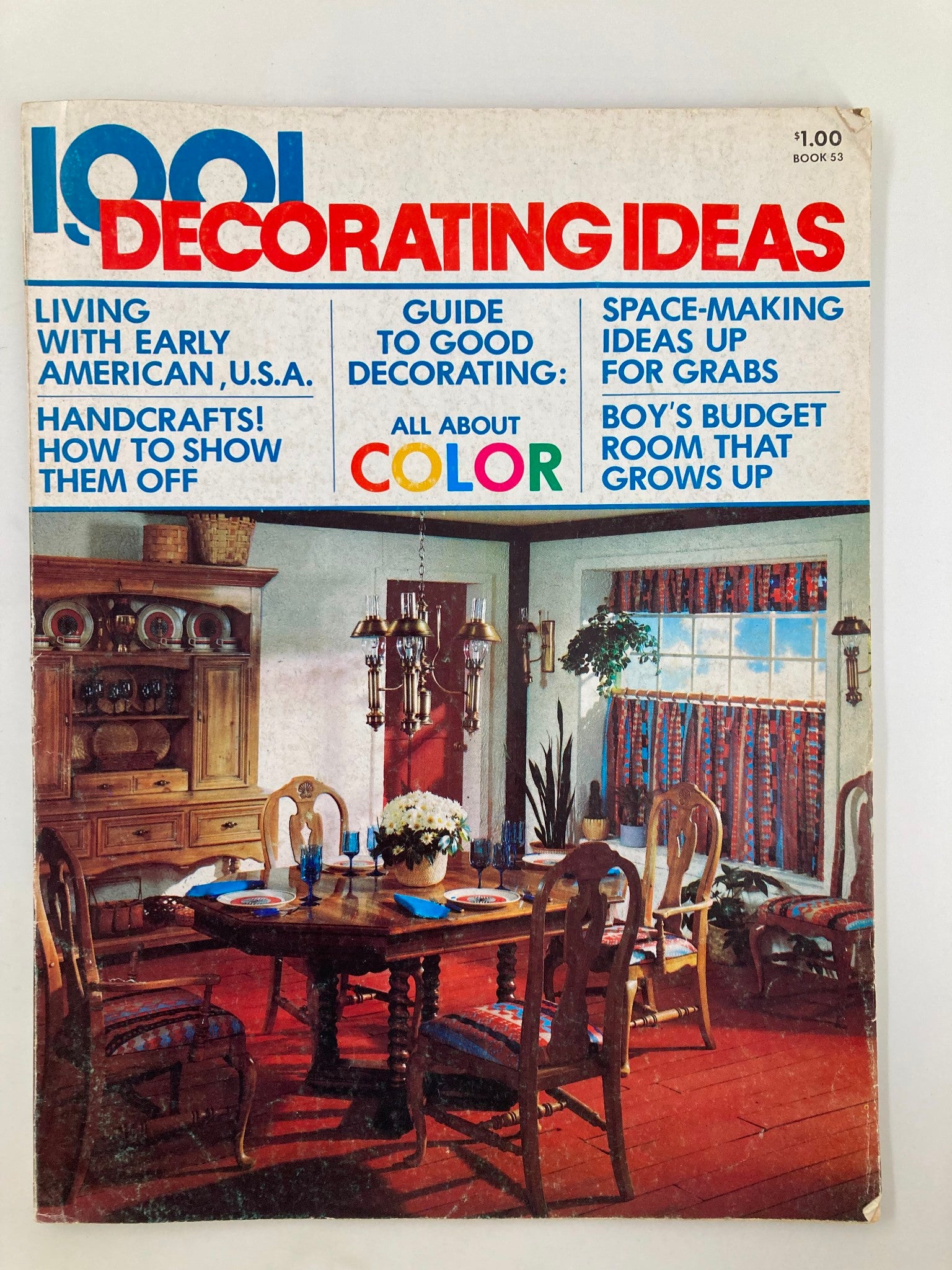 Cover of VTG 1001 Decorating Ideas Magazine 1975 featuring a dining room scene with wooden furniture, colorful patterned curtains, and a round table set for dining. The highlighted title reads 'Boy's Budget Room That Grows Up', showcasing stylish and budget-friendly decorating ideas from the 1970s.