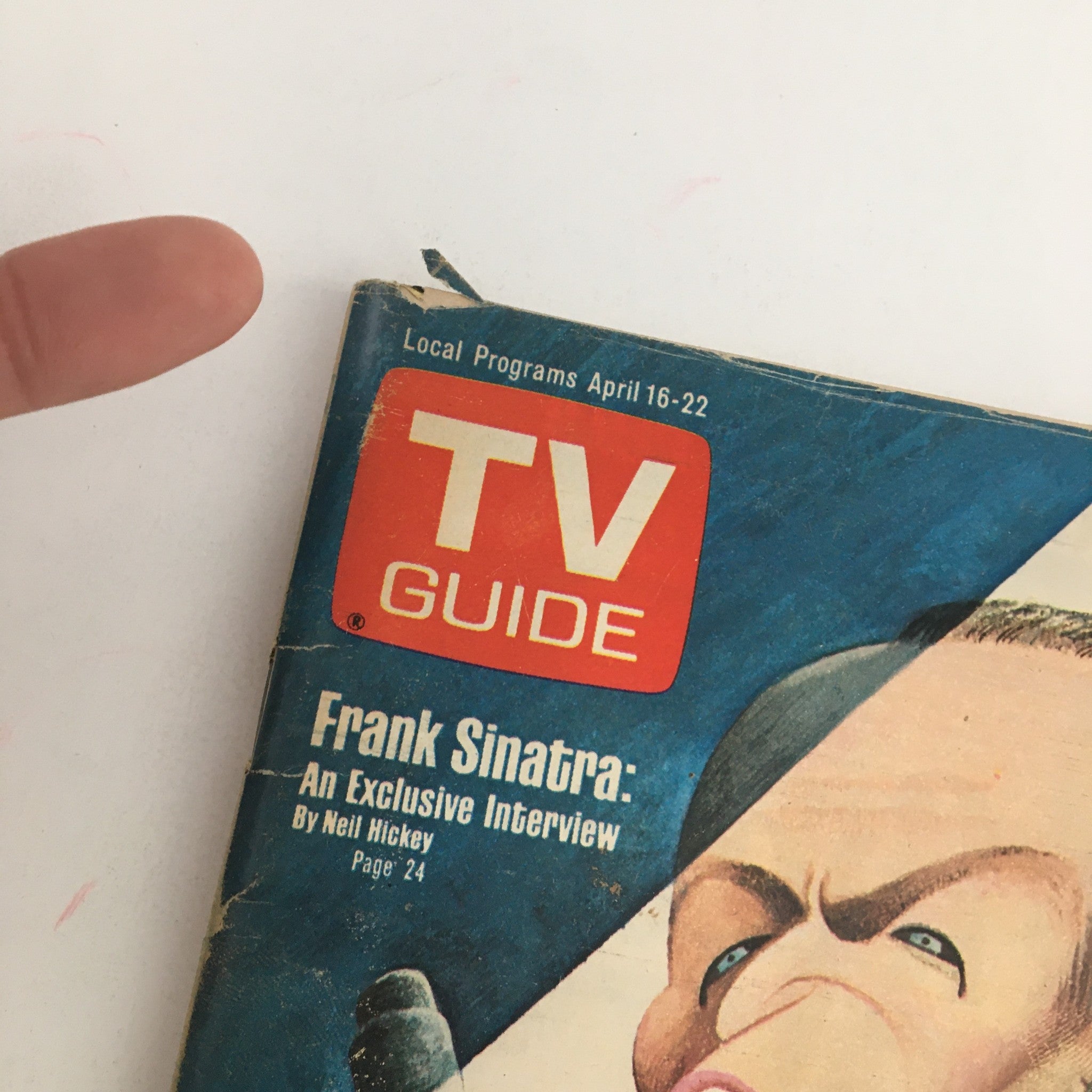 Detail view of the TV Guide Magazine April 16, 1977, showing the title 'Frank Sinatra: An Exclusive Interview' alongside the 'TV GUIDE' logo. The image captures a slight tear at the top and exhibits the magazine's vintage condition.