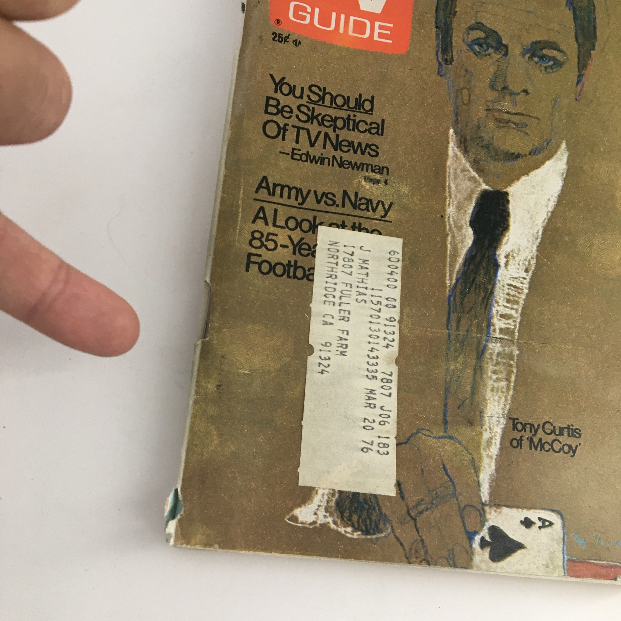 Cover of TV Guide Magazine dated November 29, 1975, featuring Tony Curtis of 'McCoy'. The magazine displays a hand pointing at a list of articles, including commentary on TV news and a feature on Army vs. Navy football.